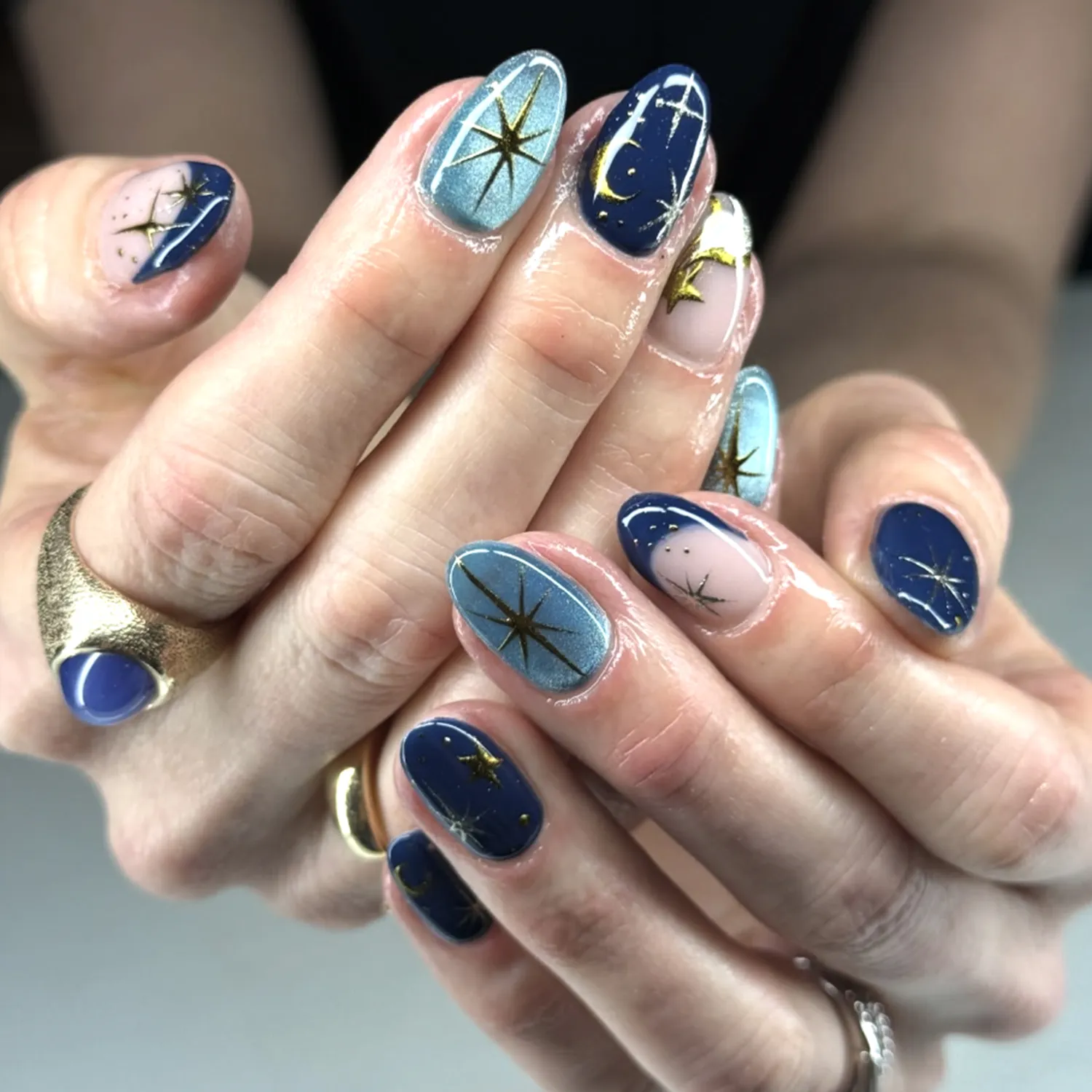 Hands with detailed blue nail art