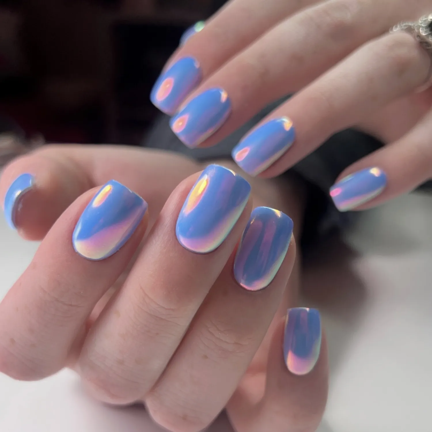 Hands with polished nails in a reflective and smooth finish