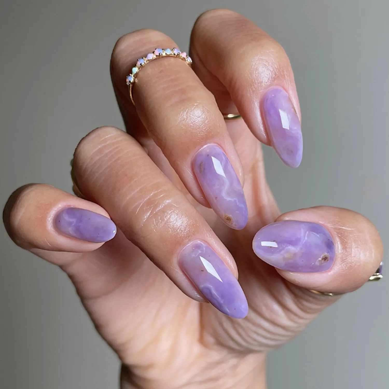 A hand with manicured nails in a polished style