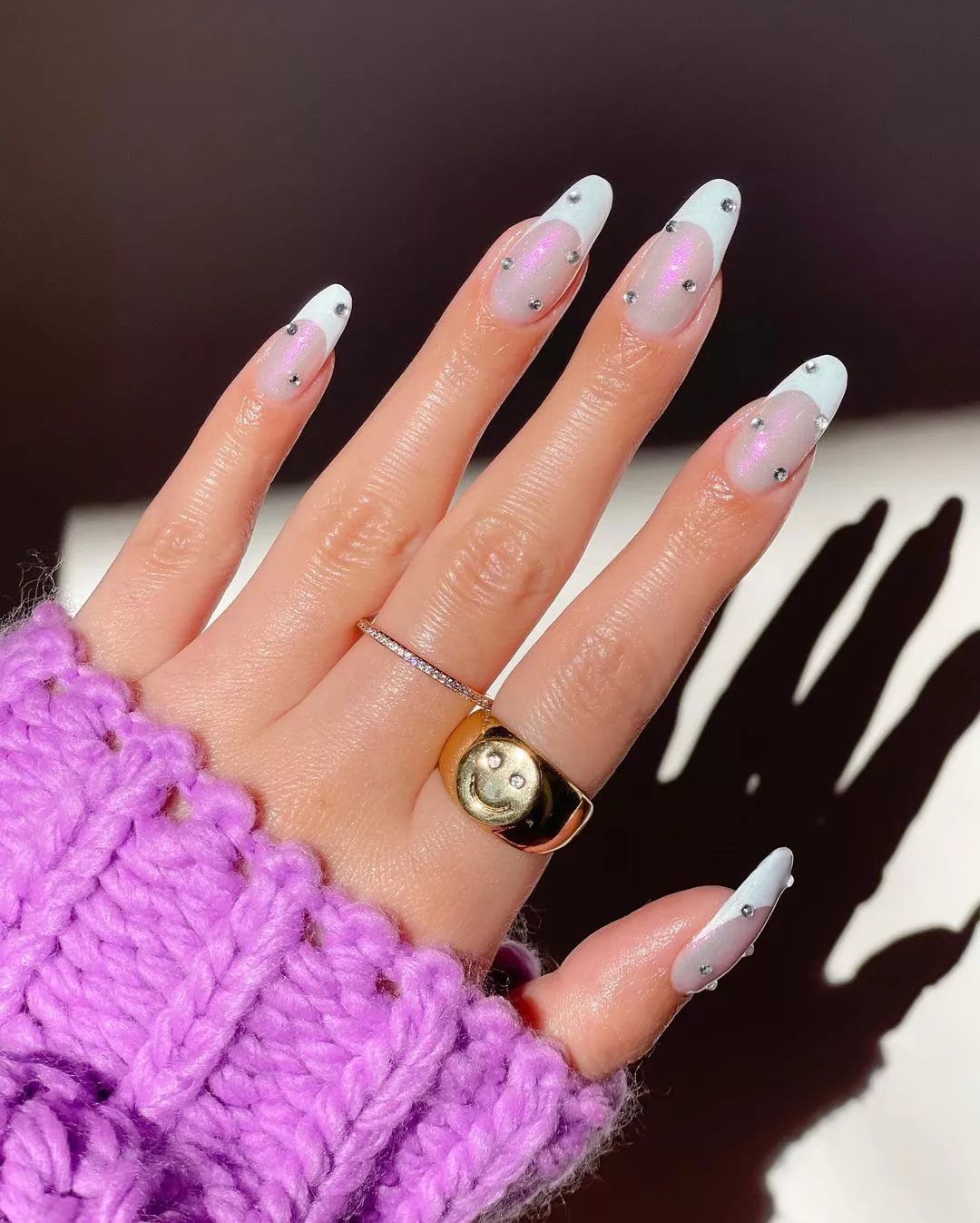 french manicures with chrome and glitter coat with added rhinestone