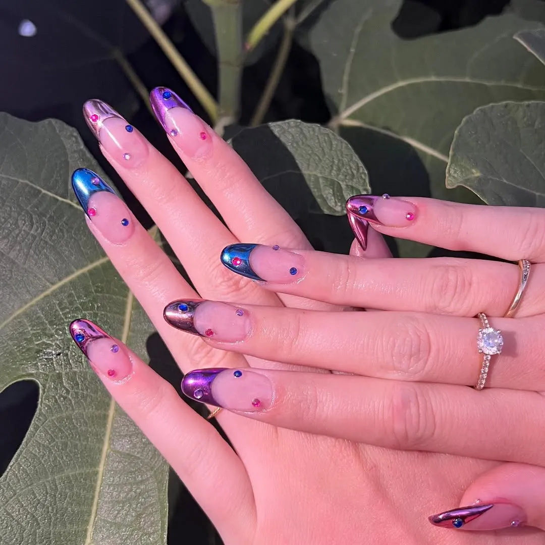 Hands with decorative manicure displayed over a leafy background