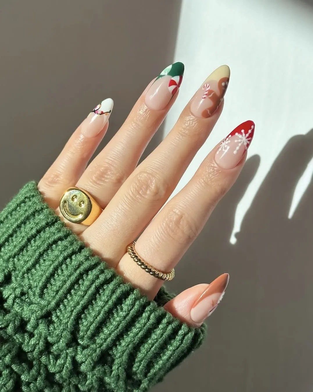 Snowflake nails with various colorful French tips and holiday-themed art.