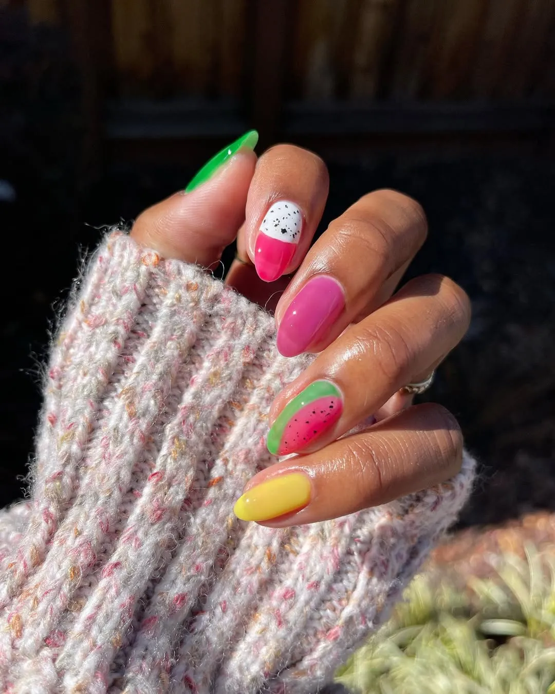 Person shows off their sheer jelly nails, which have two fruity accent nails