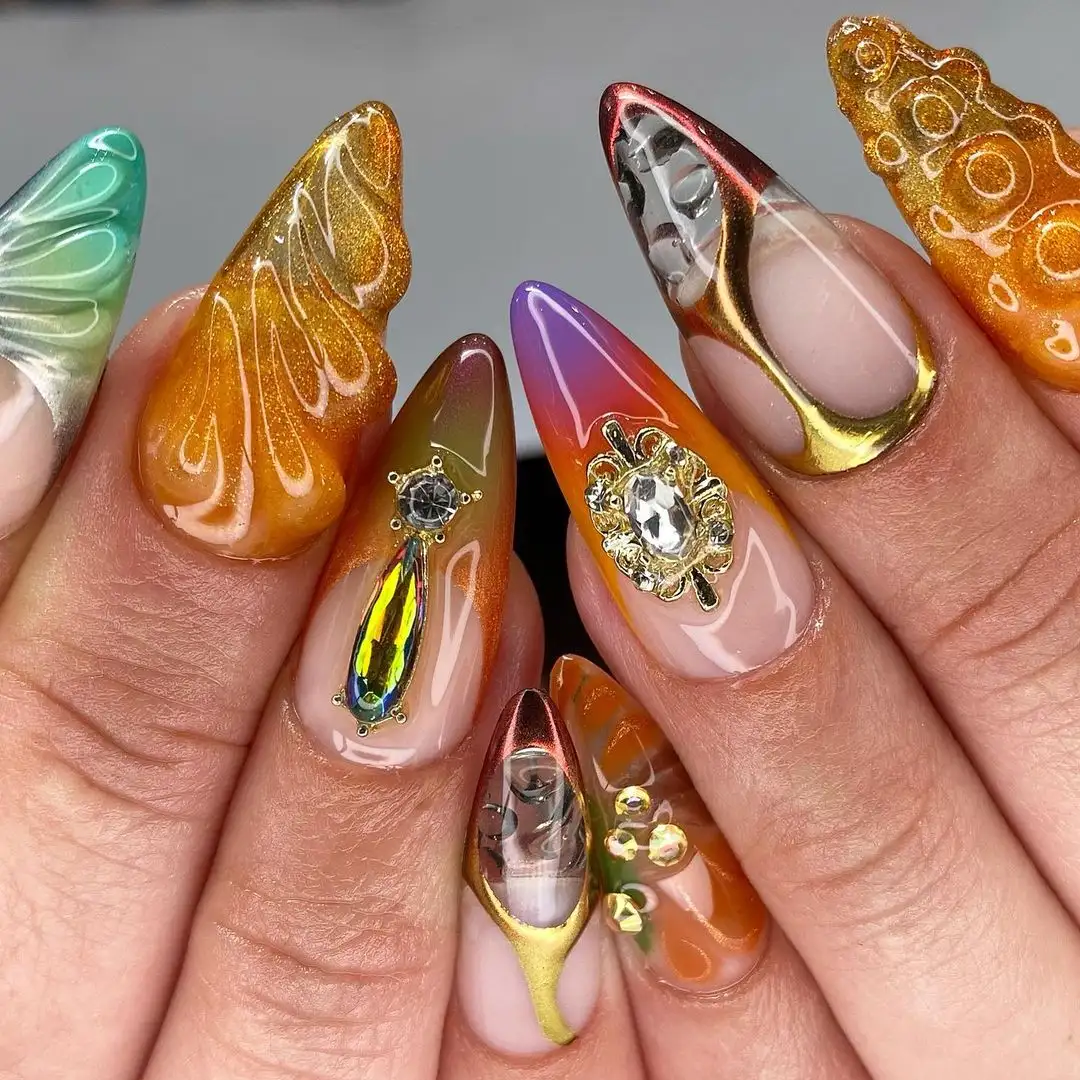 Intricate nail art designs on acrylic nails featuring various details and gem embellishments