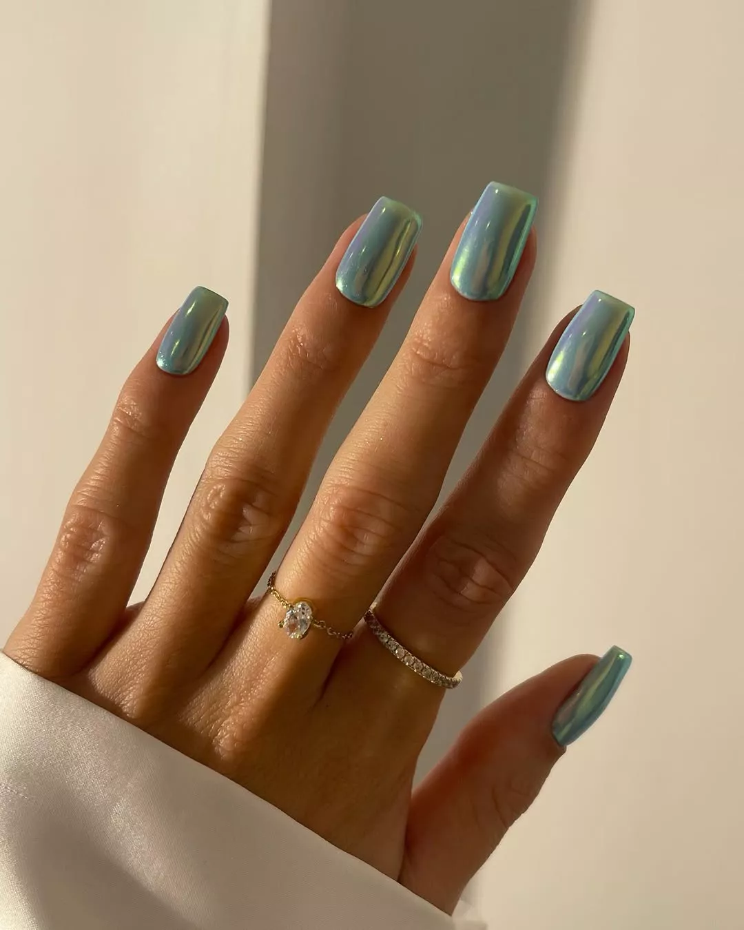 Aqua chrome nails that are medium length and square shaped