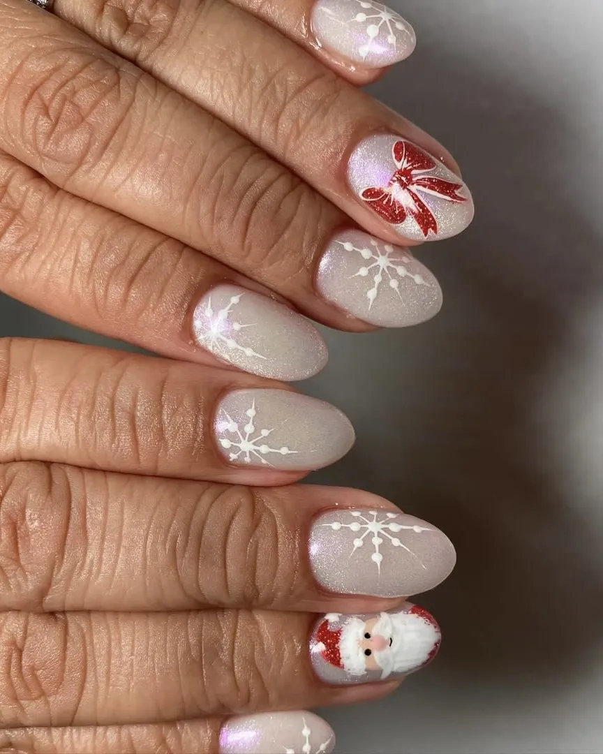 White glittery snowflake nails with a red bow accent nail.