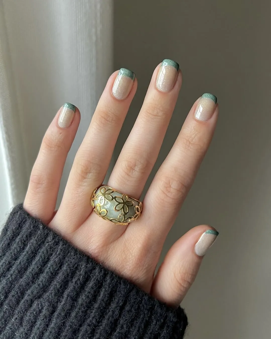 Sparkly green French Christmas nails.