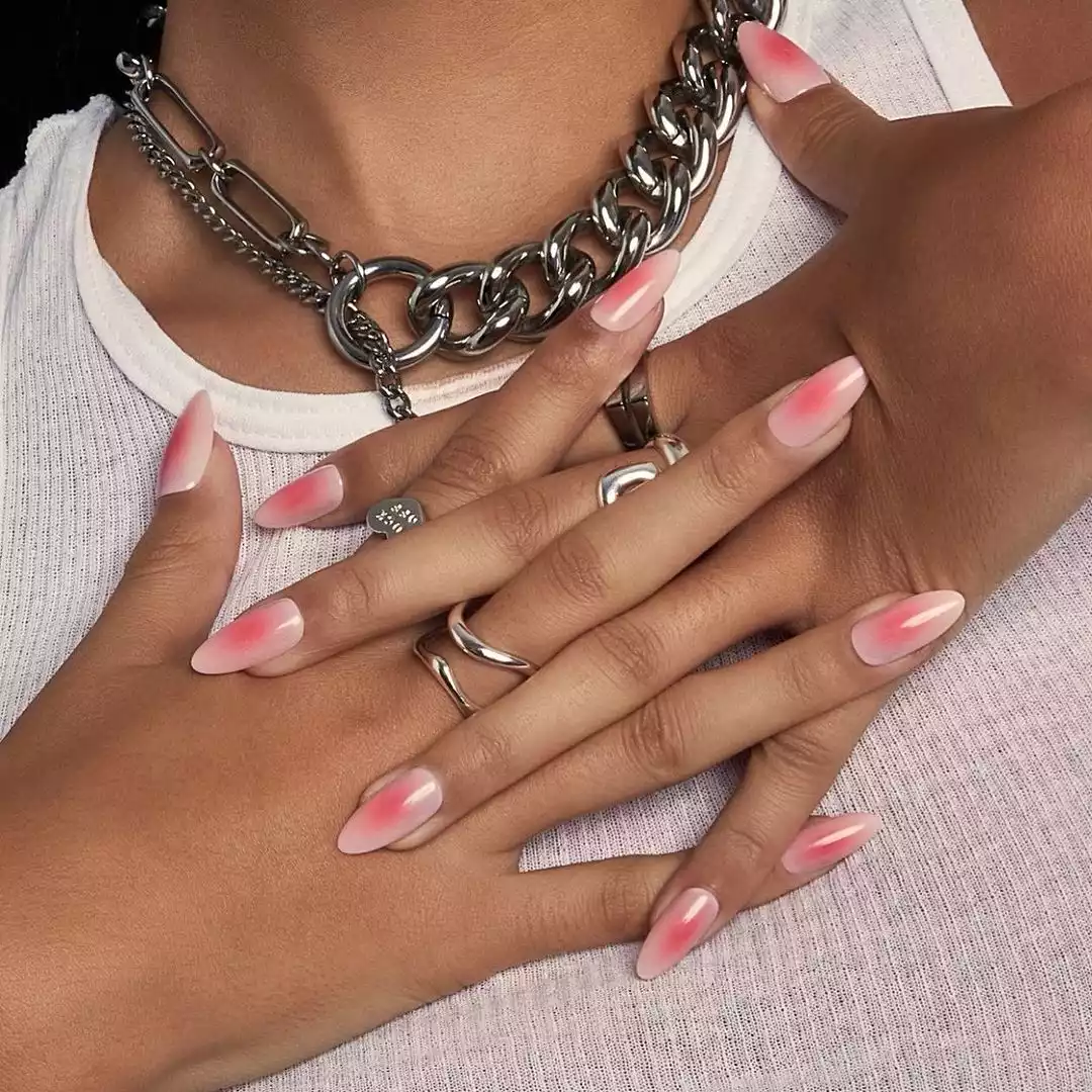 Medium-length, almond- and oval-shaped nails with a bright pink middle and light pink edges
