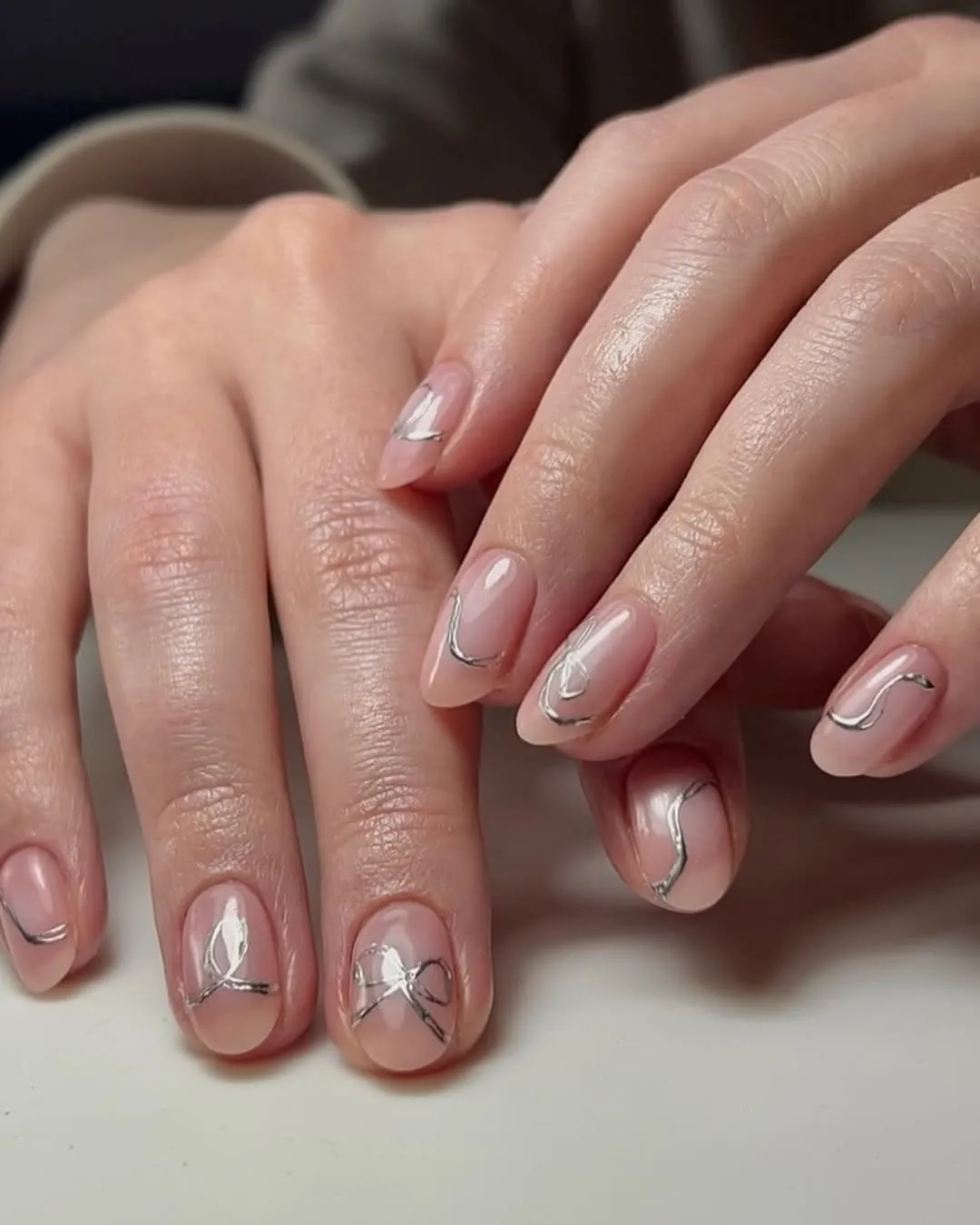 Clear nails with silver bows
