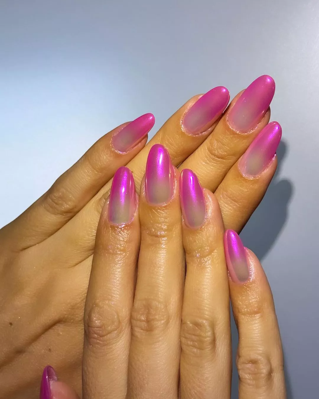 Person shows off their ombre pink French manicure, which is long and rounded