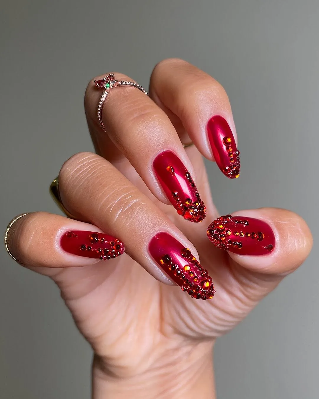 A hand with decorated fingernails holding a pose