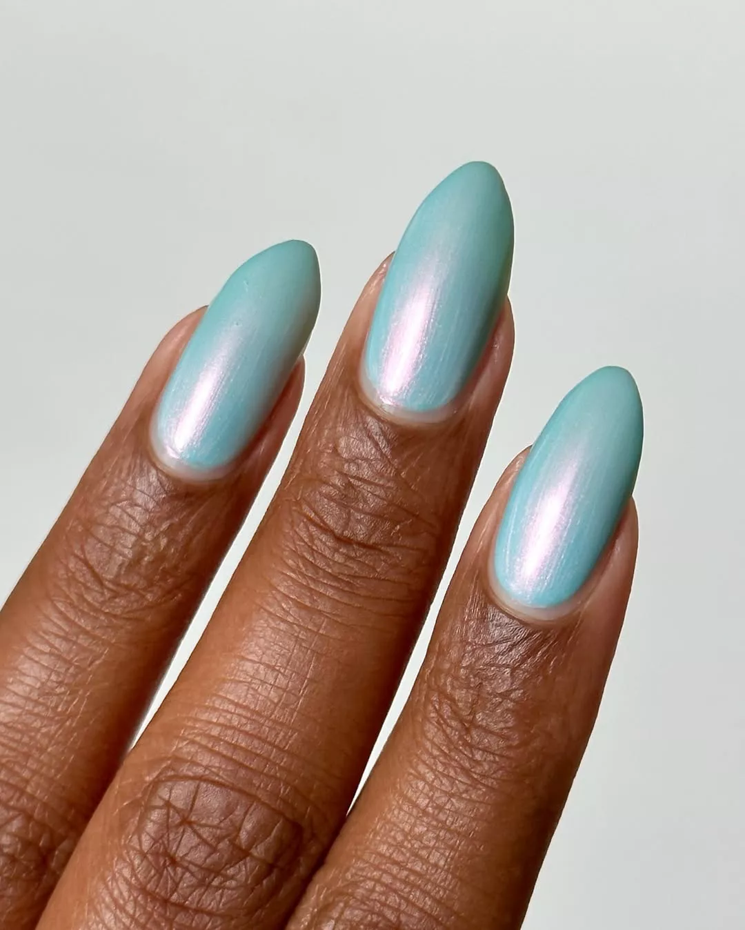 Aqua blue manicure on almond shaped nails