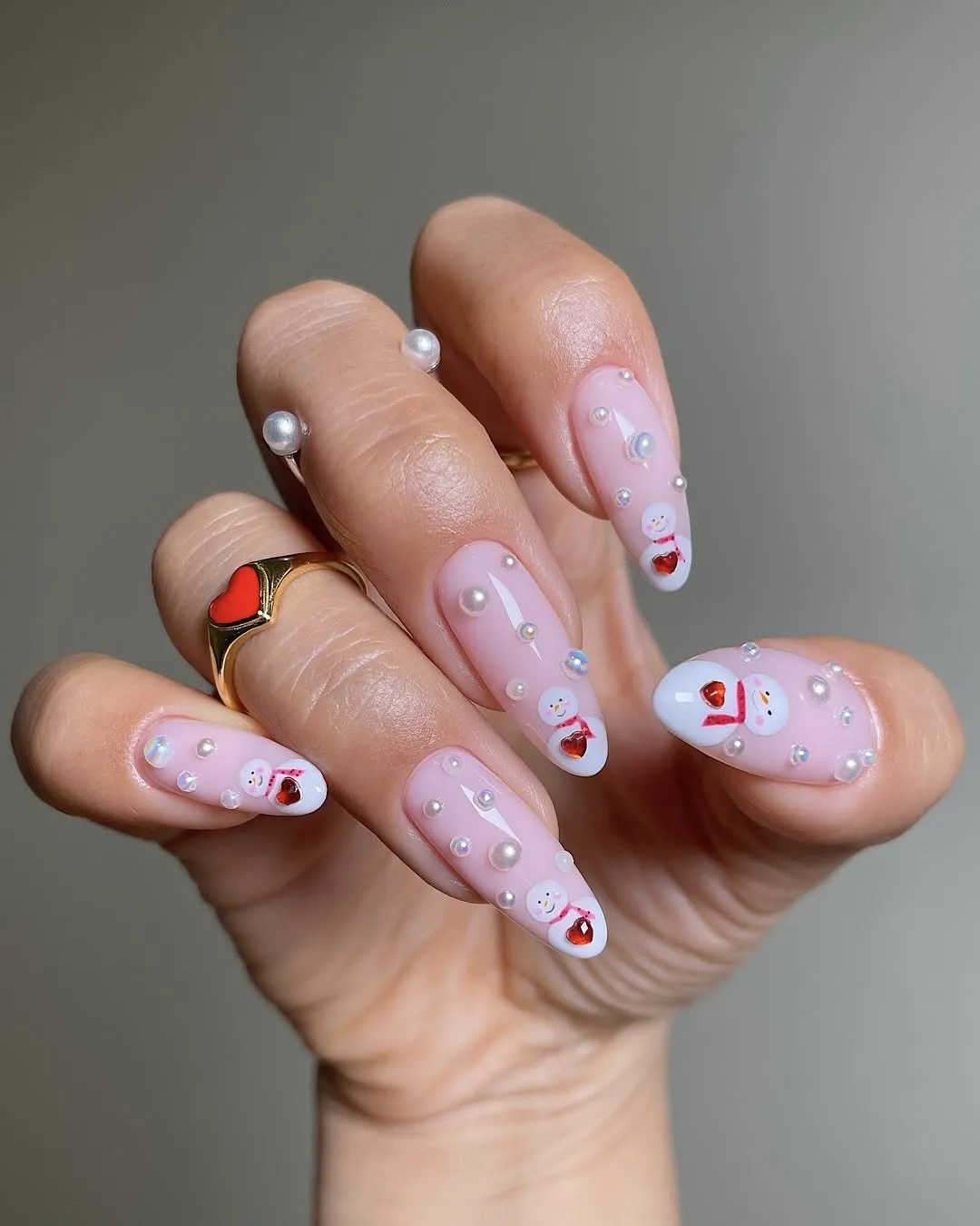 Snowman nails with 3D pearl embellishments.