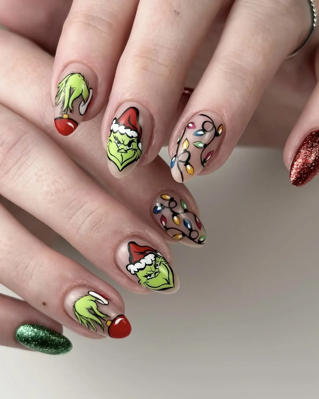 Classic grinch nails with glitter accents.