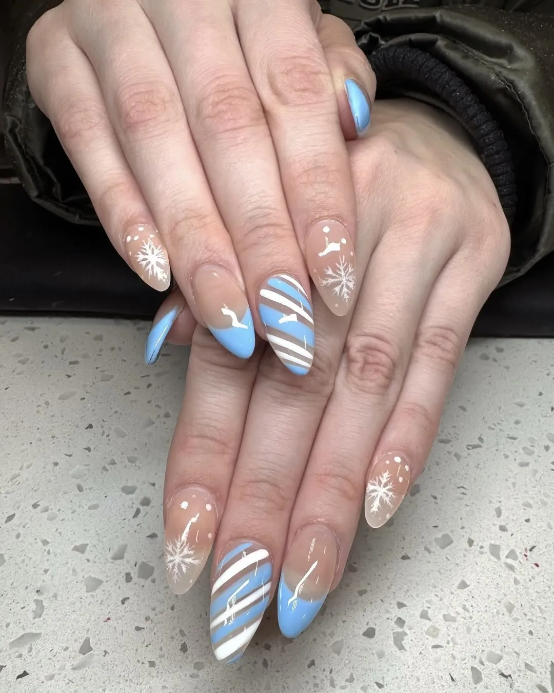 Light blue striped snowflake nails.