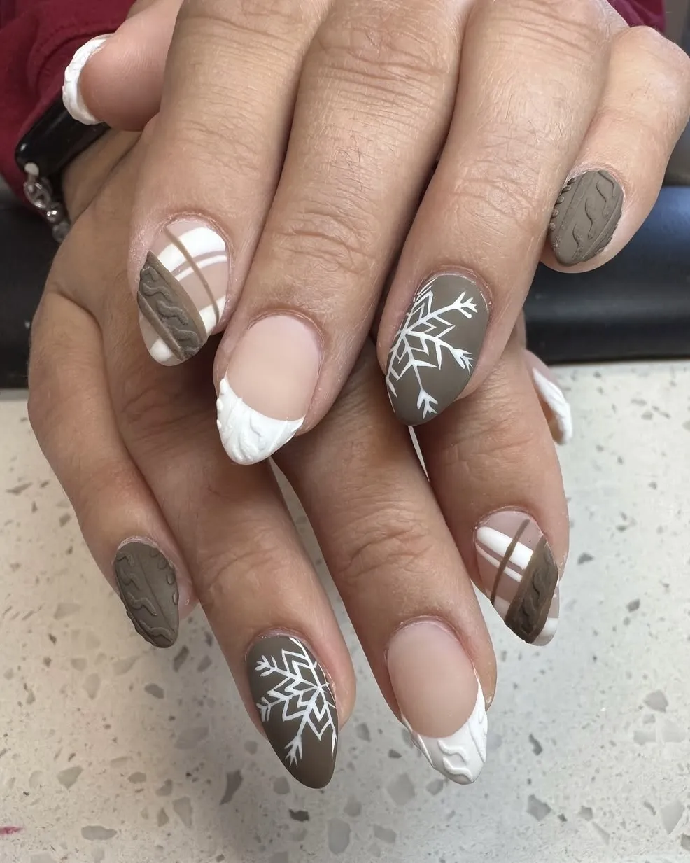 Brown plaid, sweater texture, and snowflake nails.