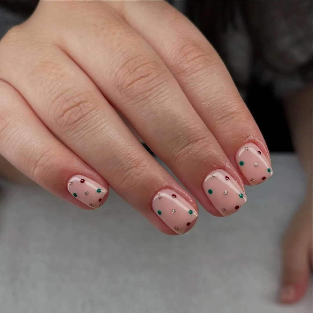 Nude nails with multicolored glittery polka dots