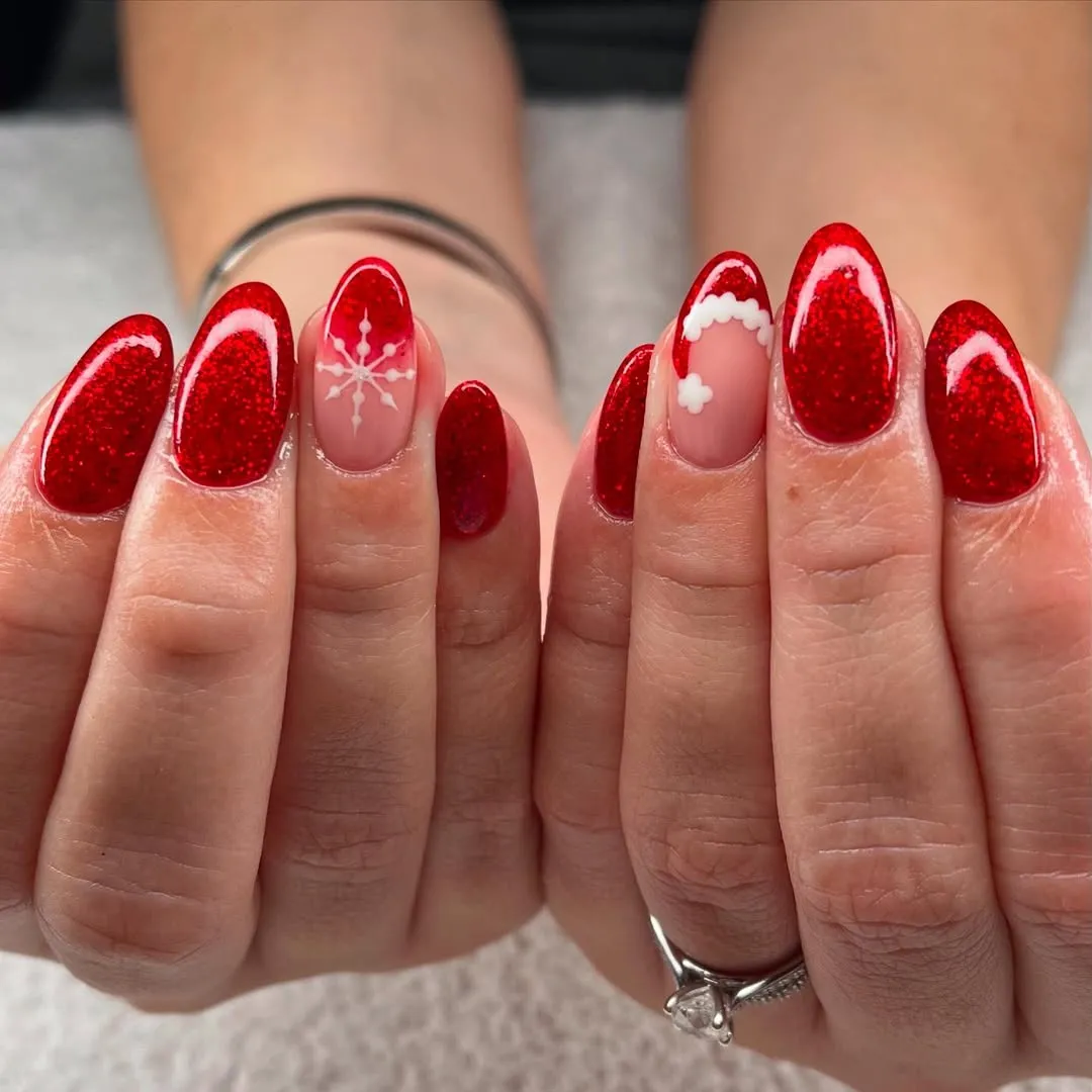Manicured hands with red polished nails featuring design accents