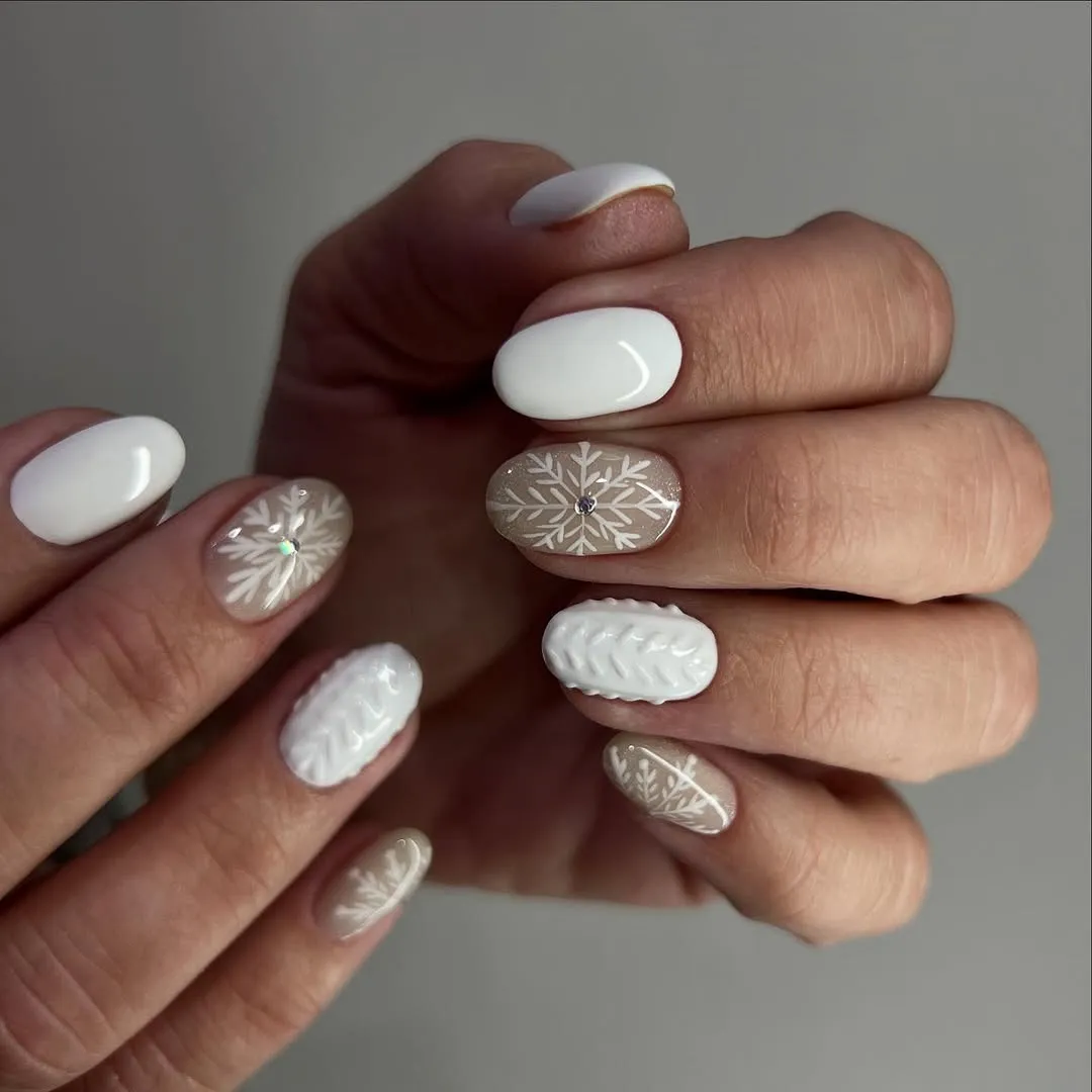White manicure with snowflake accent nails and cable knit pattern