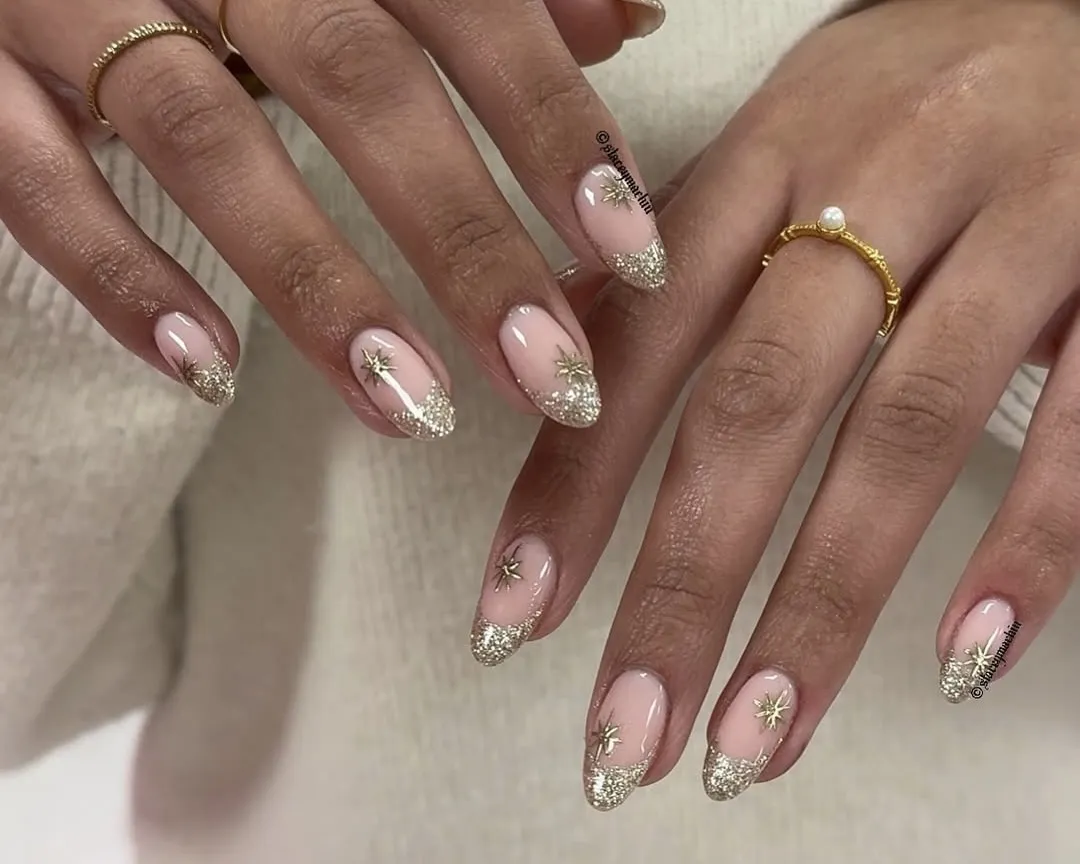 Gold glitter and twinkle holiday nails.