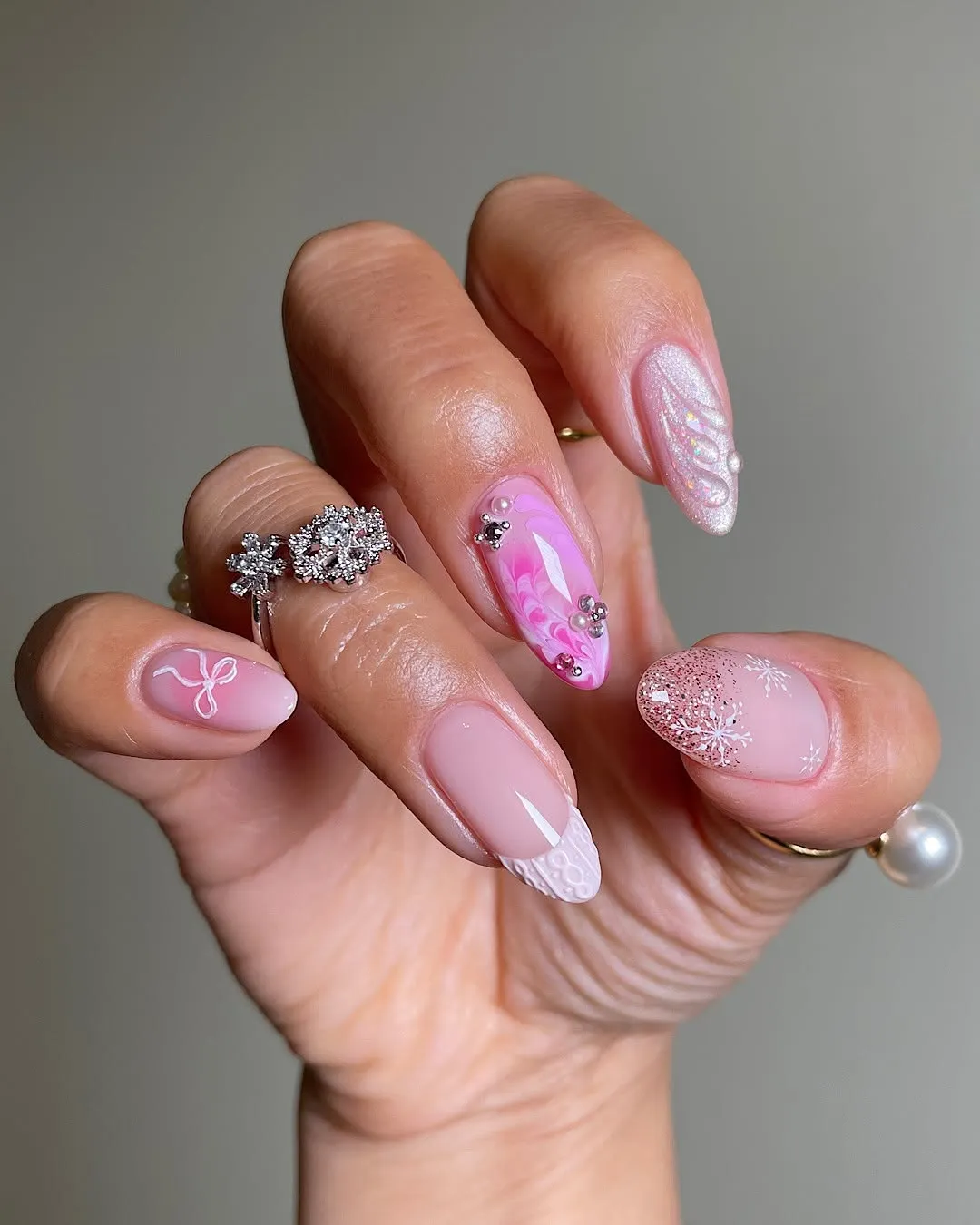 Manicured hand with decorated nails and jewelry on fingers