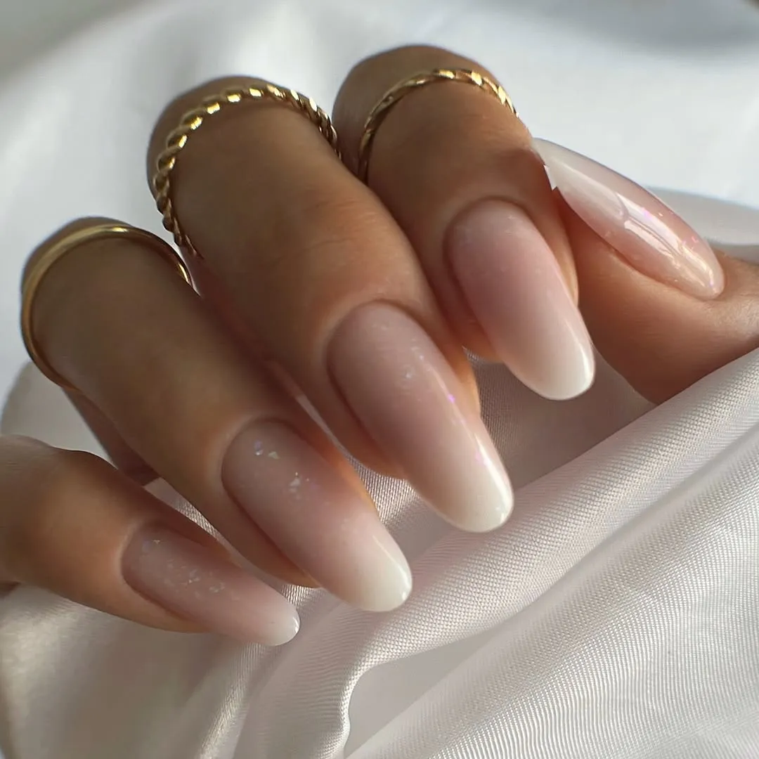 Closeup of fingers with manicured nails and gold rings