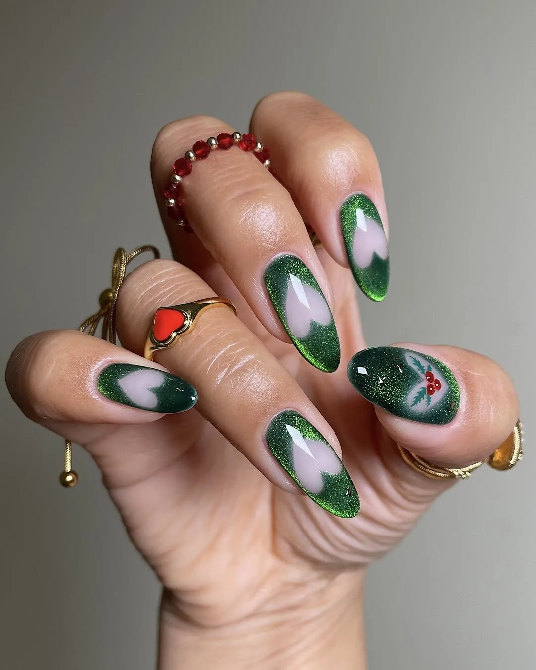 Green velvet nails with negative-space hearts.