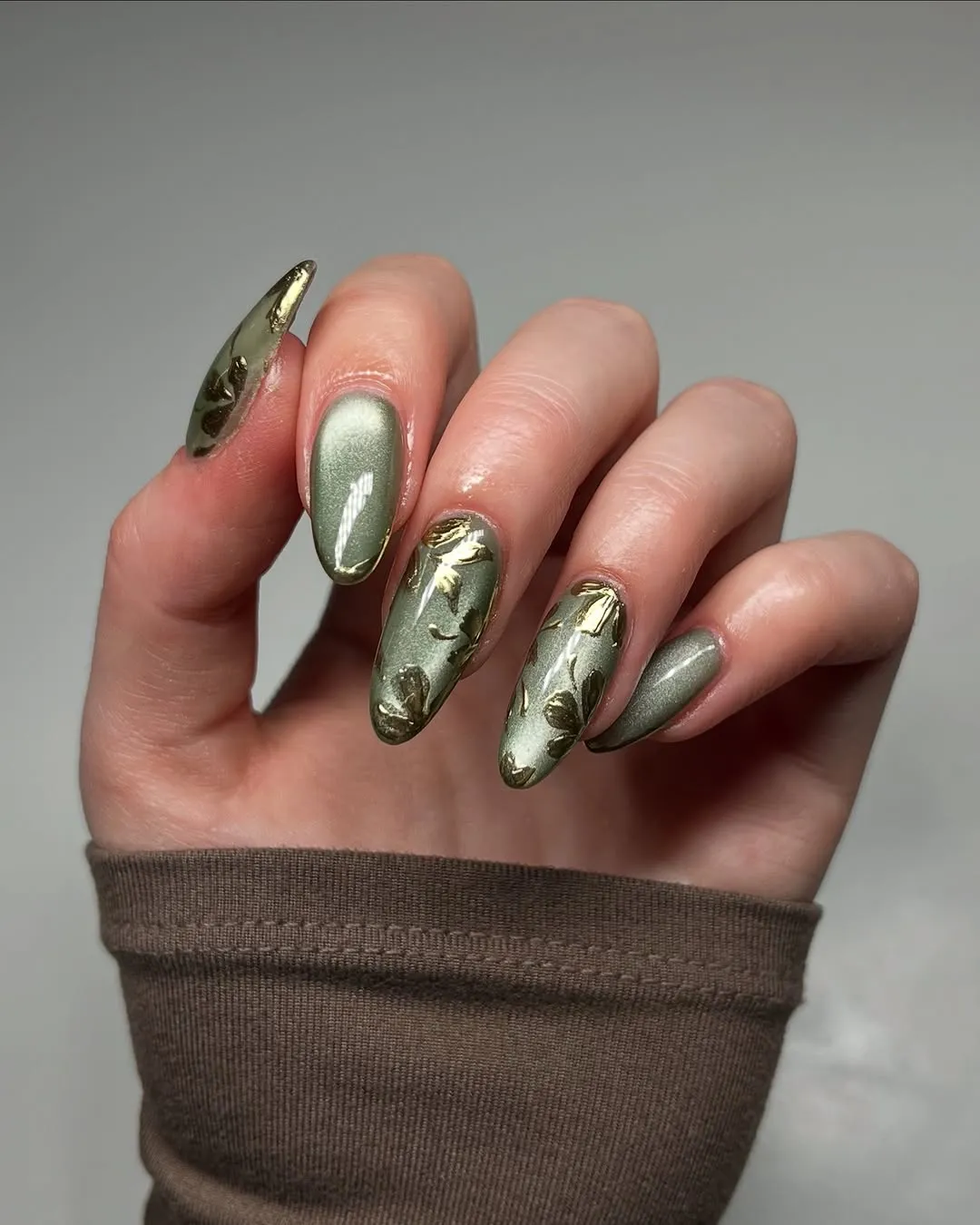 Hand with decorative metallic nails