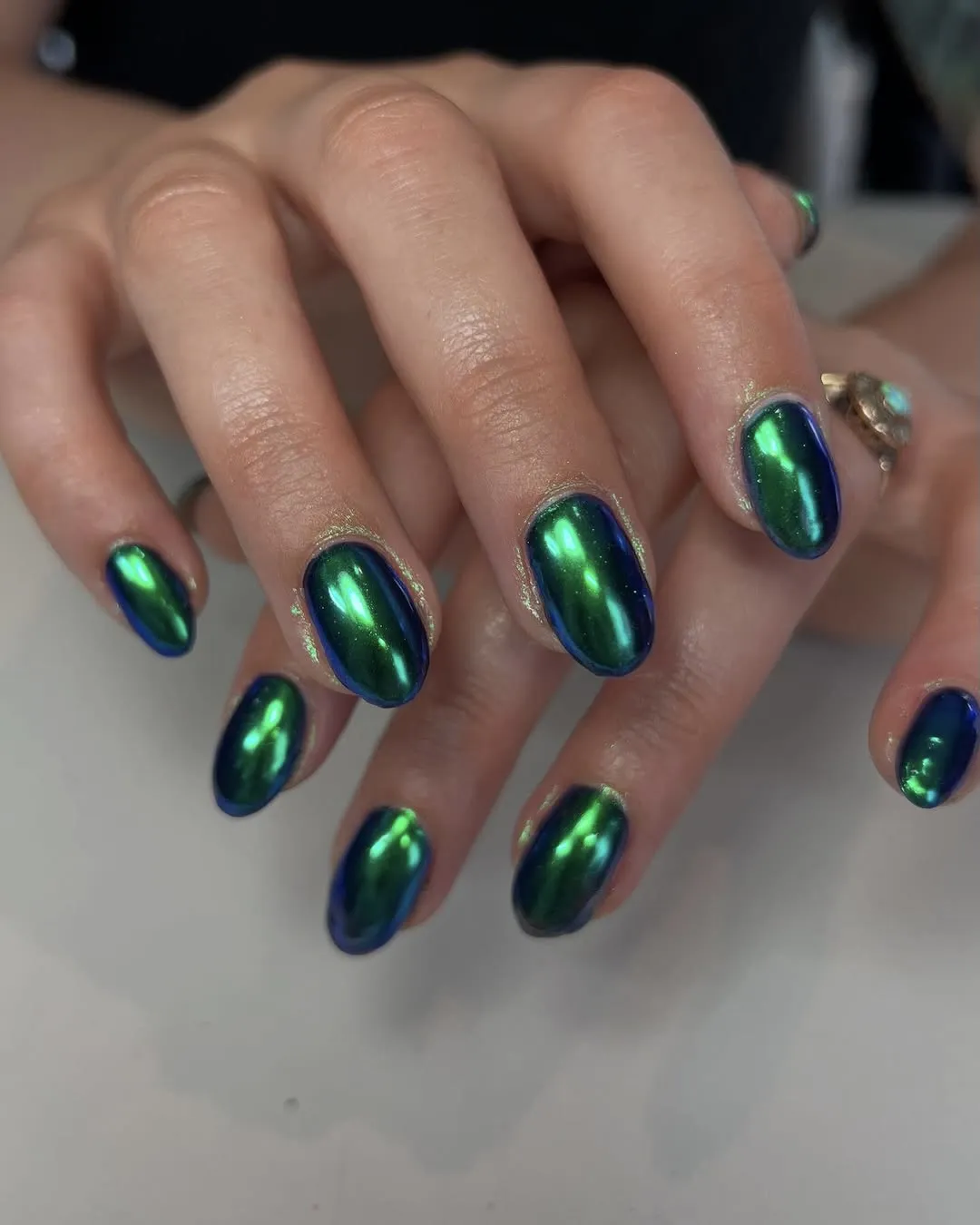 Mermaid green chrome nails.
