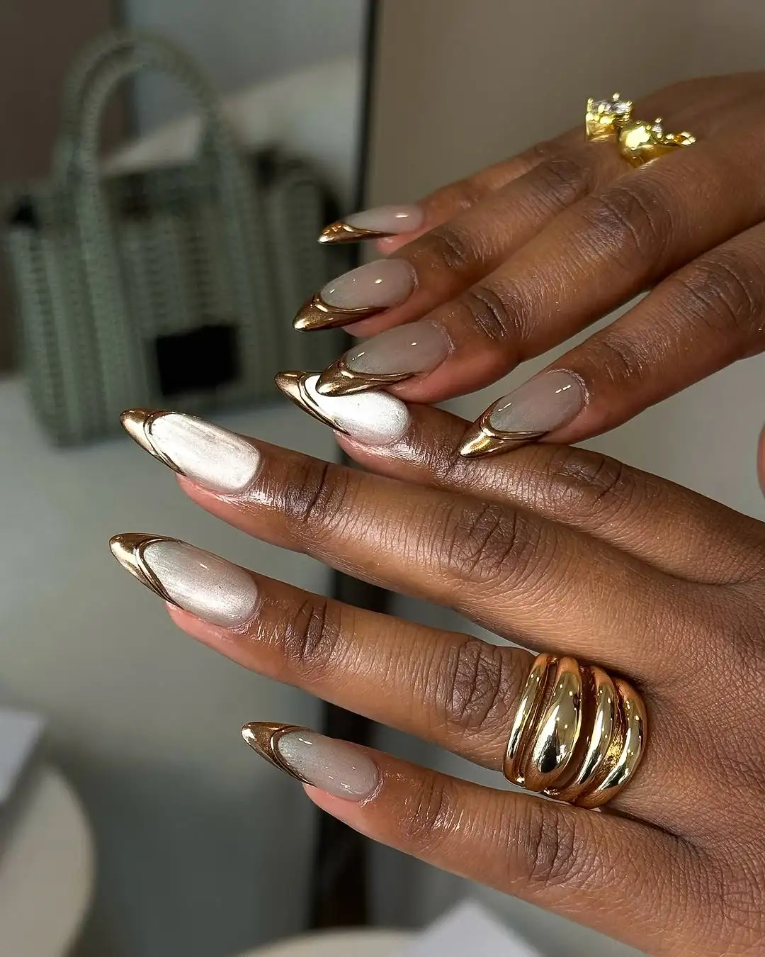 Metallic champagne nails with gold chrome French tips