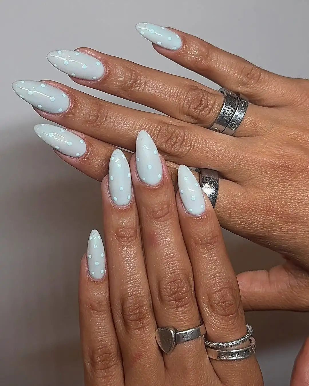 Milky baby blue nails with opaque baby blue polka dots