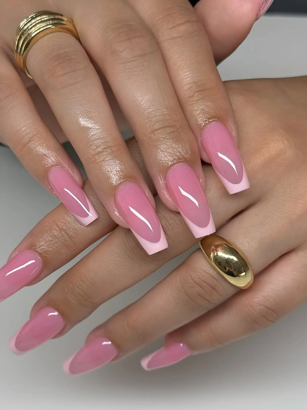Sheer pink nails with an opaque pink French tip