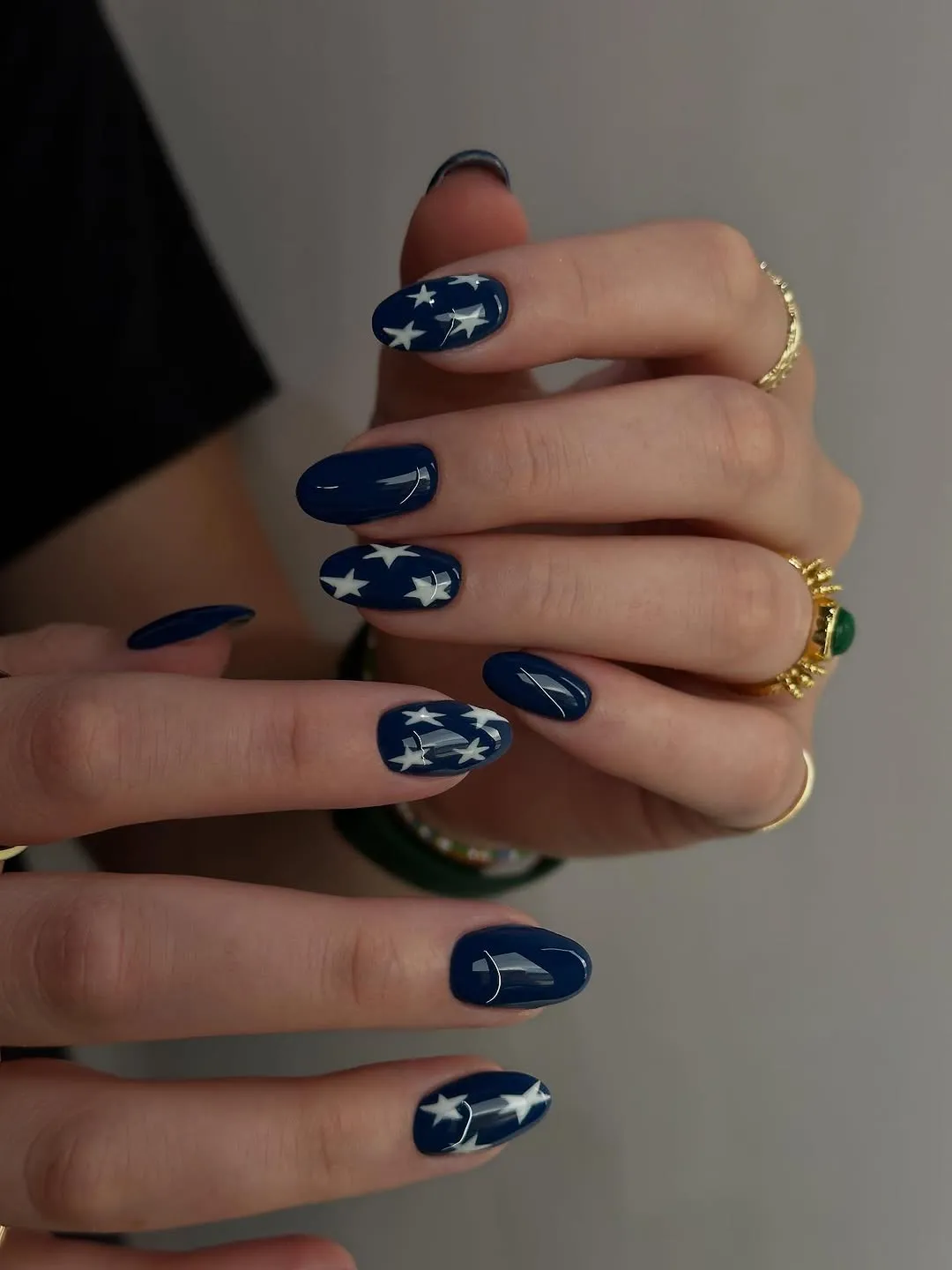Hands with nail art featuring star patterns rings on fingers