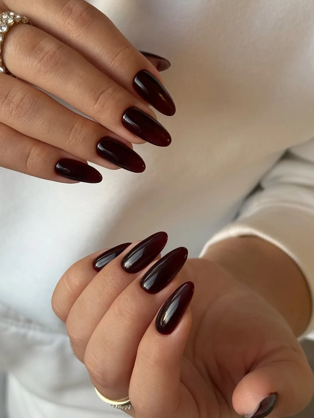 Hands showcasing dark polished nails closeup of fingers
