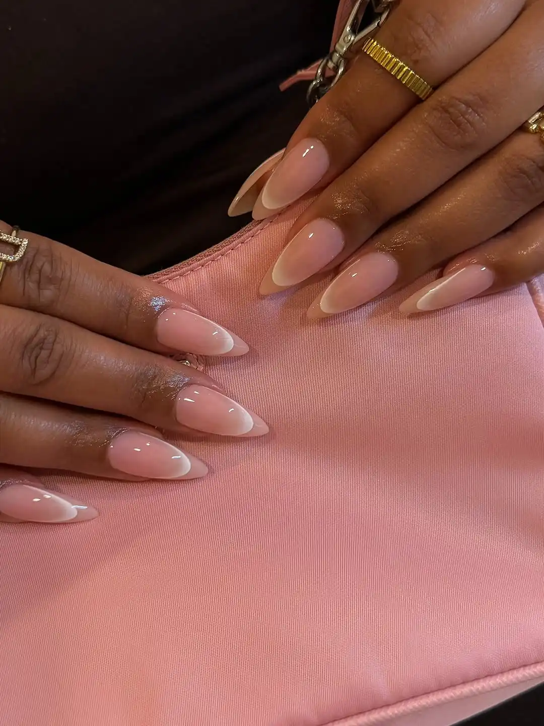 White ombre nails on a pink purse