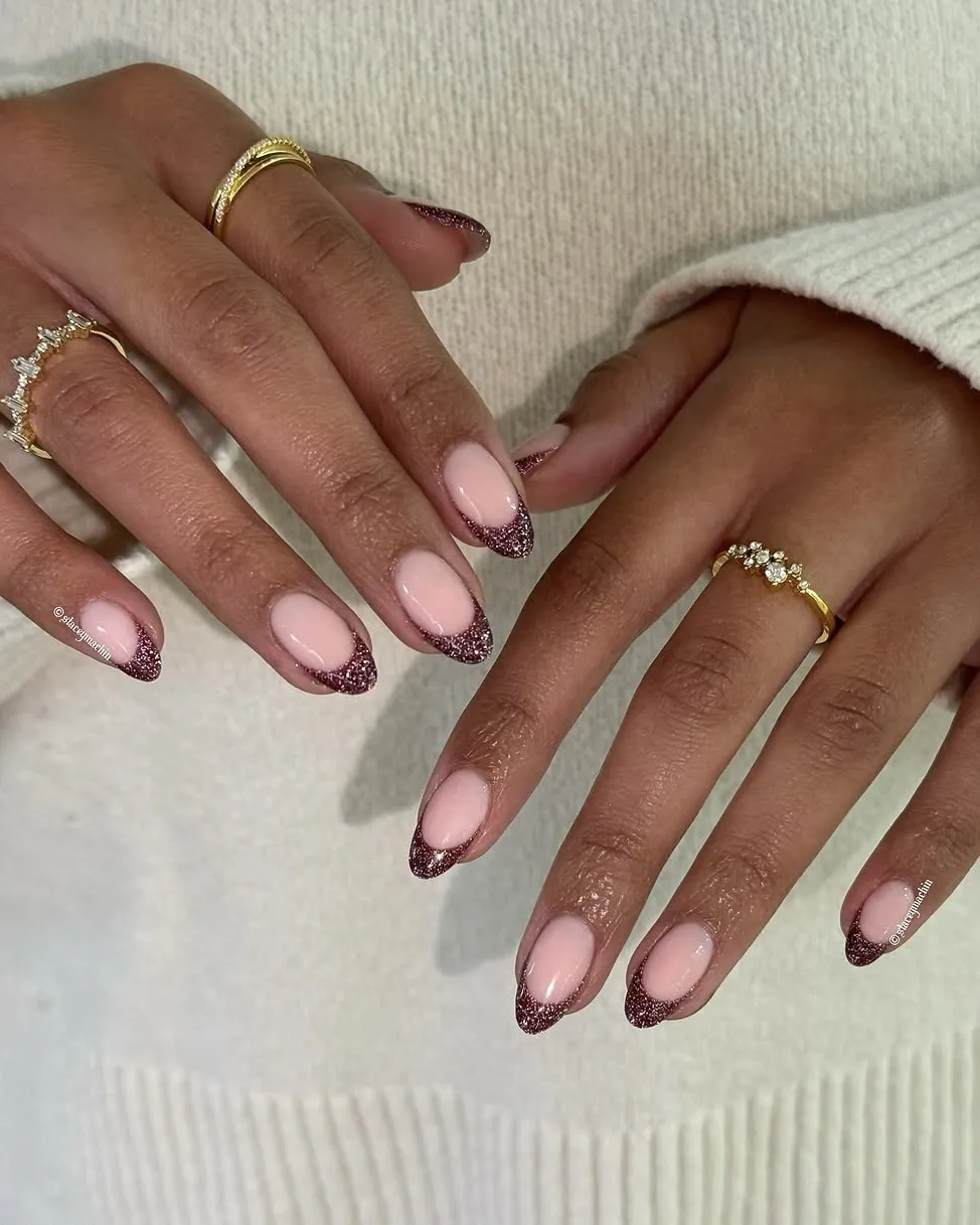 Wine-colored glitter French tips.