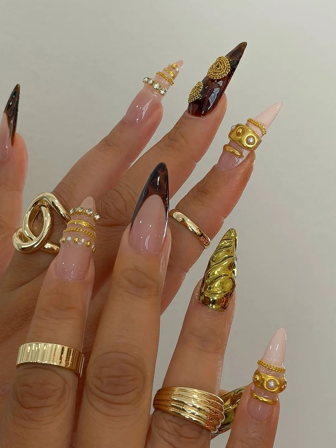 Nude, tortoiseshell, and gold nails