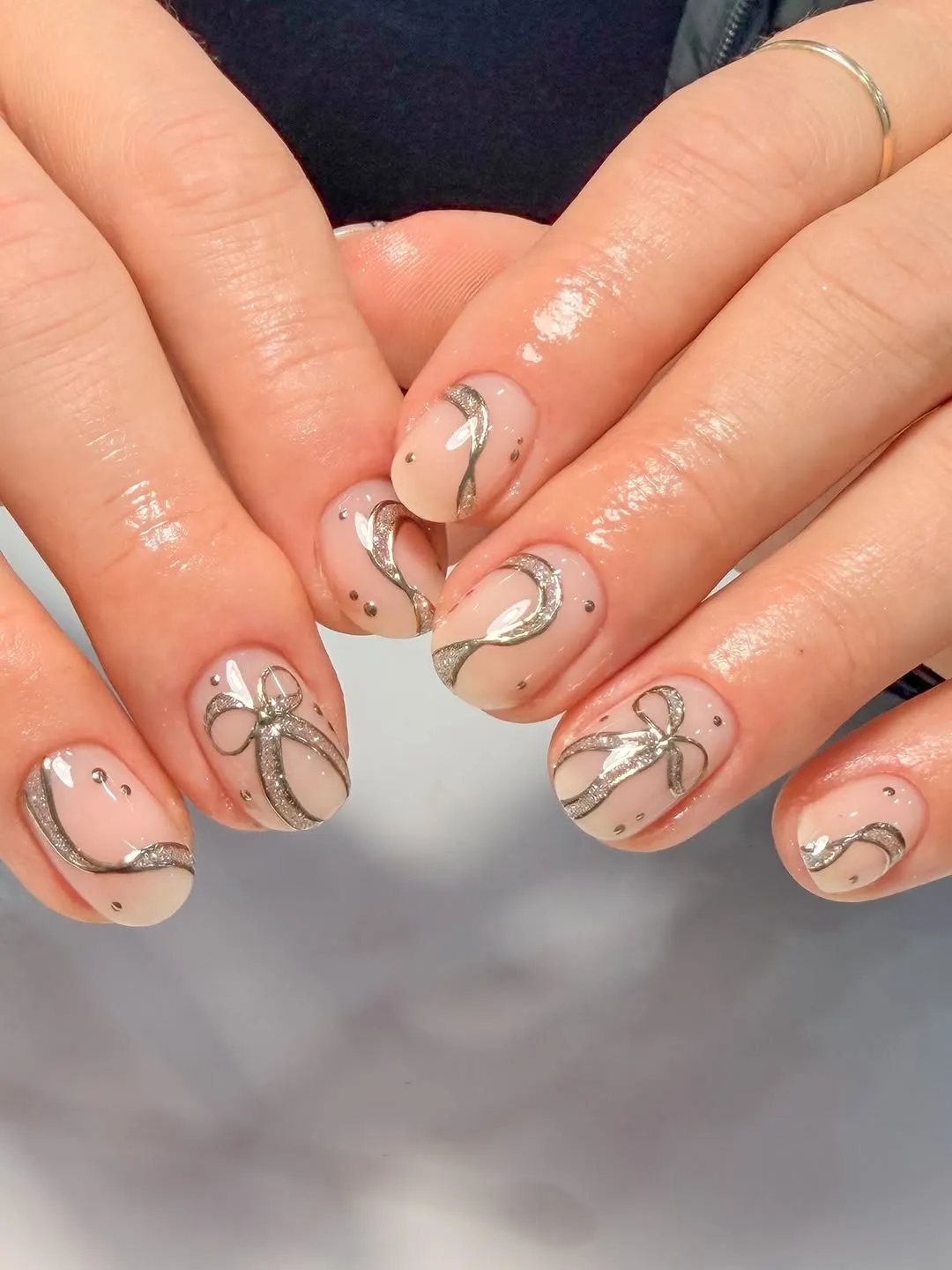 Short nails with a gold ribbon designs