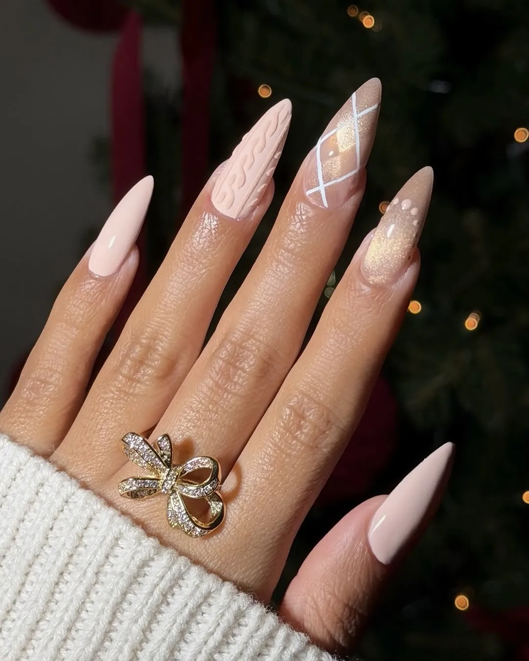 Neutral Christmas nails with sweater accent, argyle, and gold glitter.