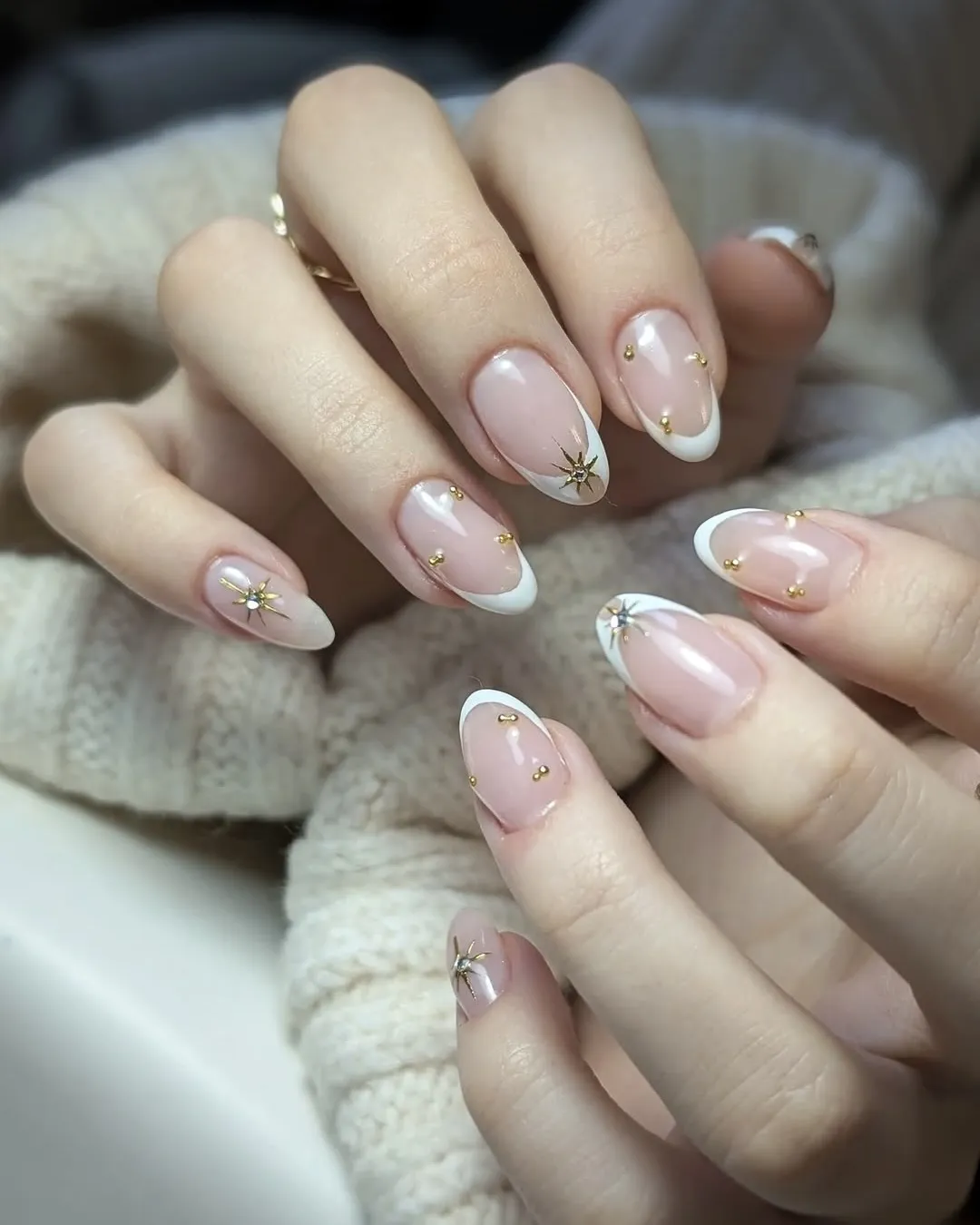 French manicure with gold accents.