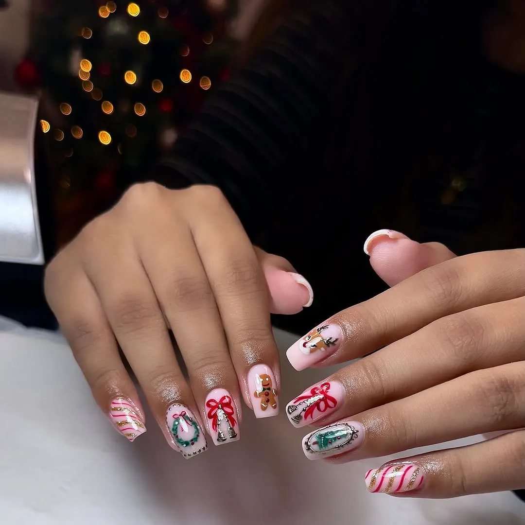 Decorative nail art with holidaythemed designs on fingernails including candy canes ribbons and a Christmas wreath