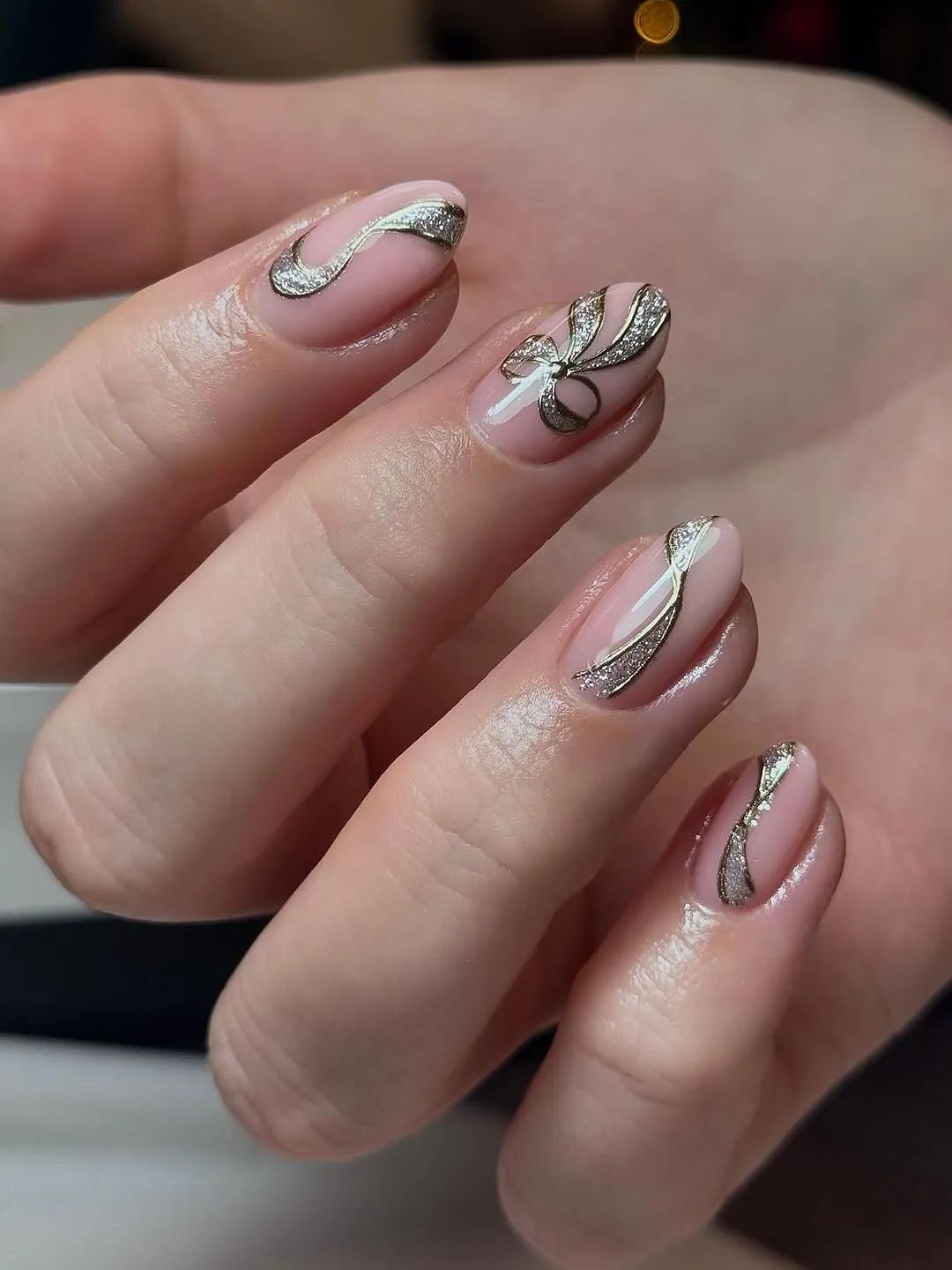 Nude nails with gold ribbon accents
