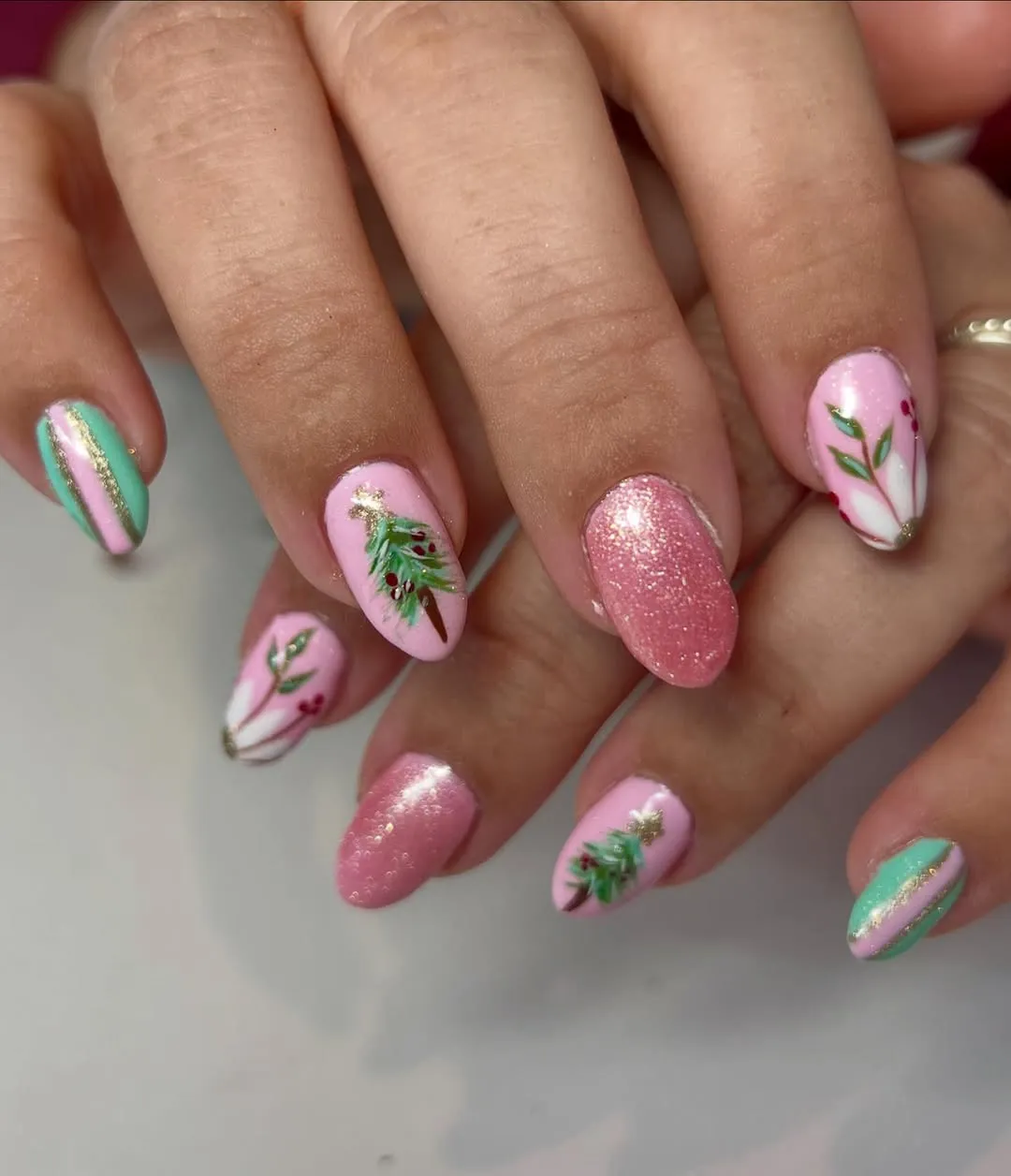 Person showing floralthemed nail art designs on their fingers