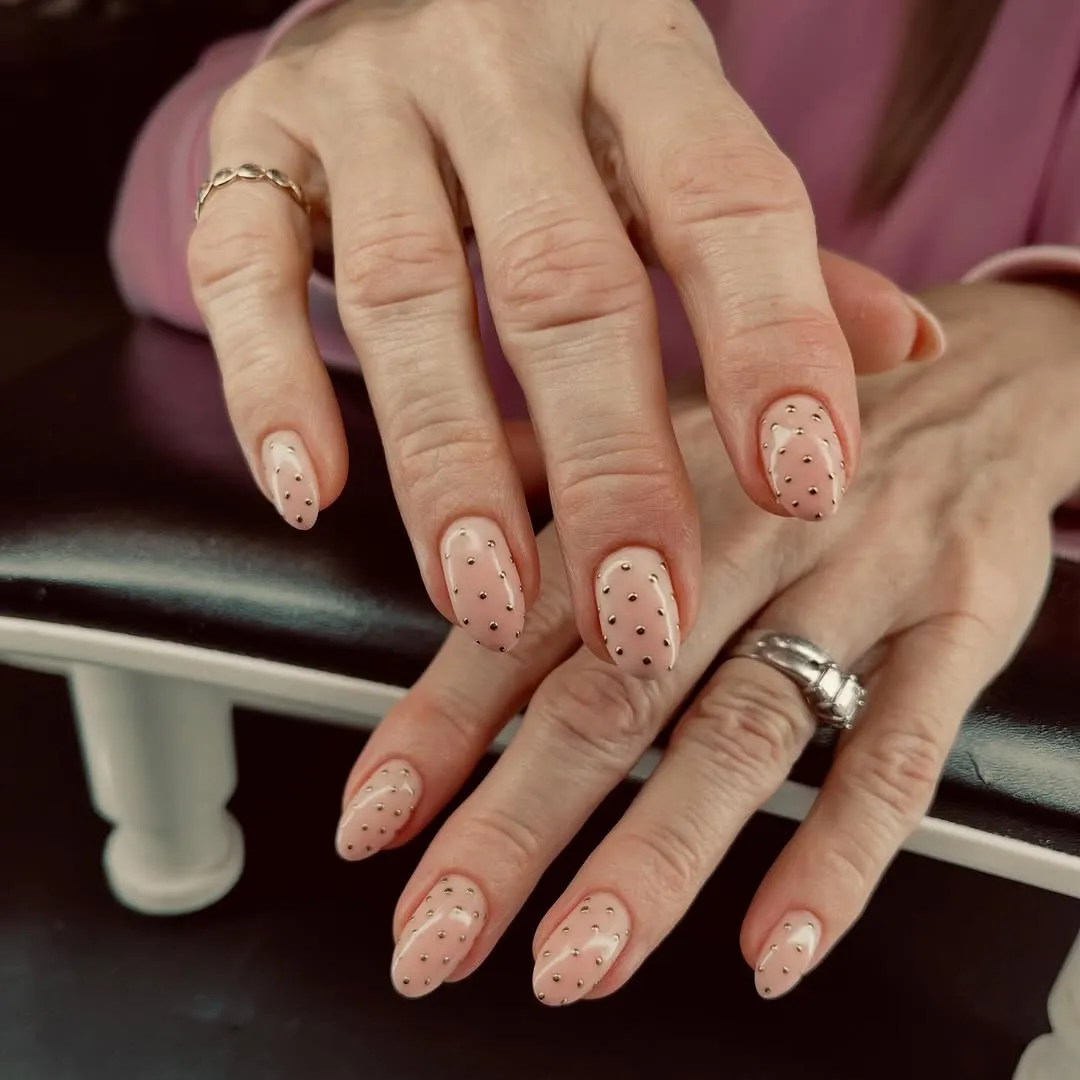 Nude nails with gold chrome polka dots