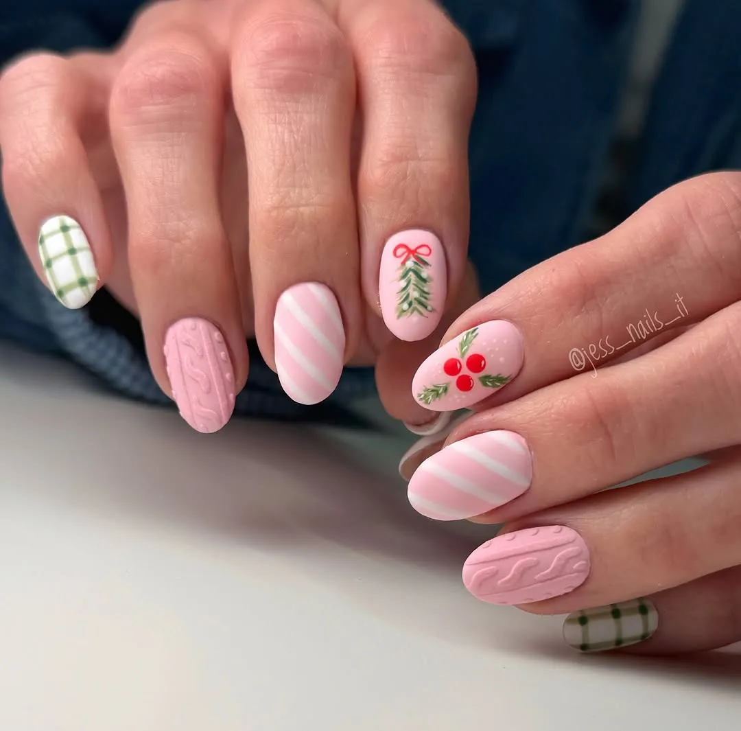 A closeup of hands showing festive nail art with patterns of stripes cable knit designs holly a tree and plaid