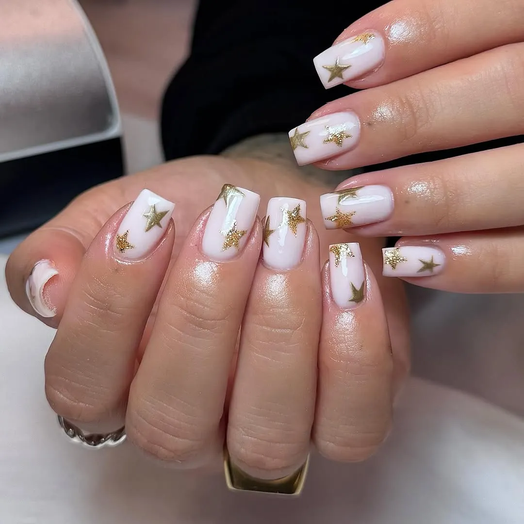 Milky white square nails with gold star designs