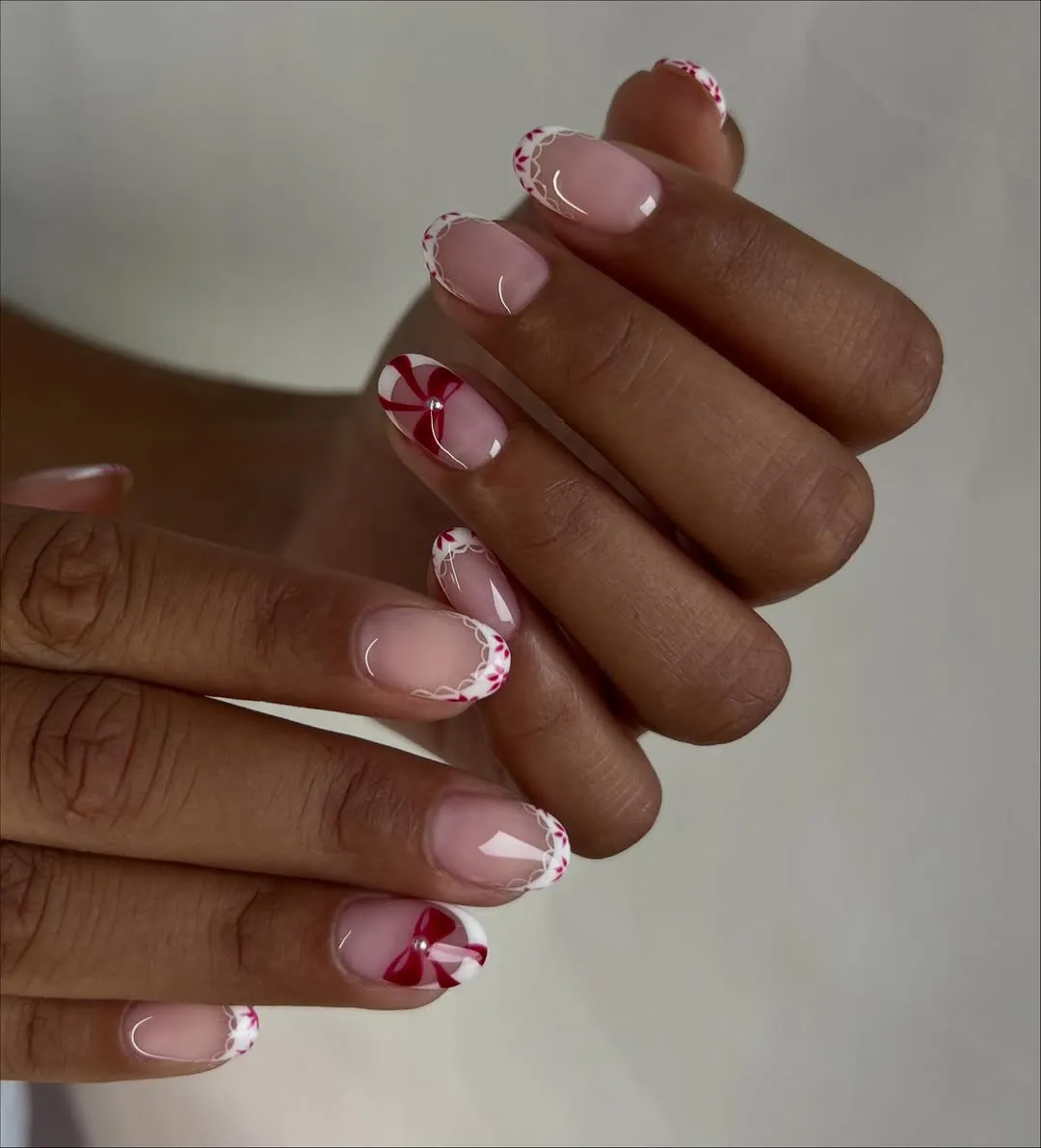 French manicure with lace edges and bow motif