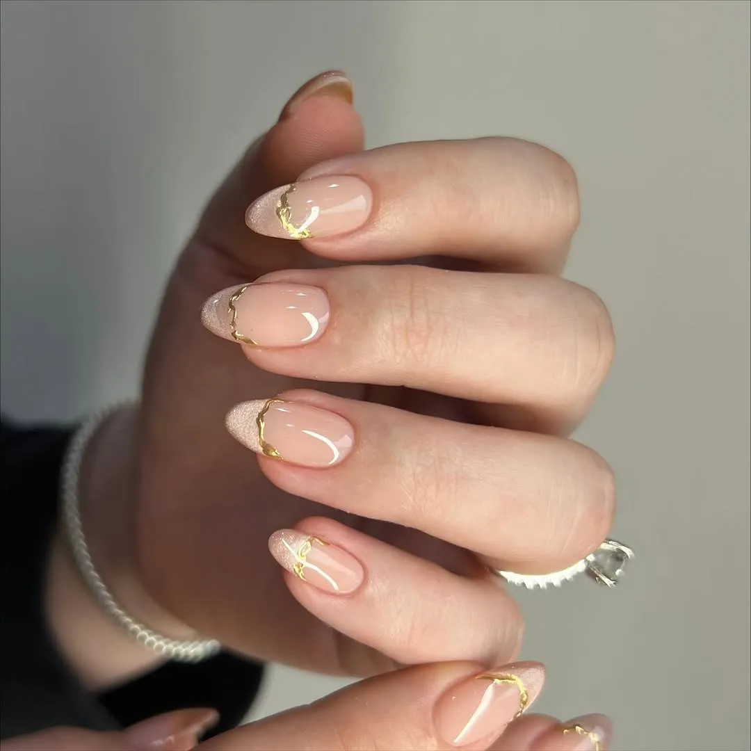 Nails with nude cat-eye French tips and gold chrome