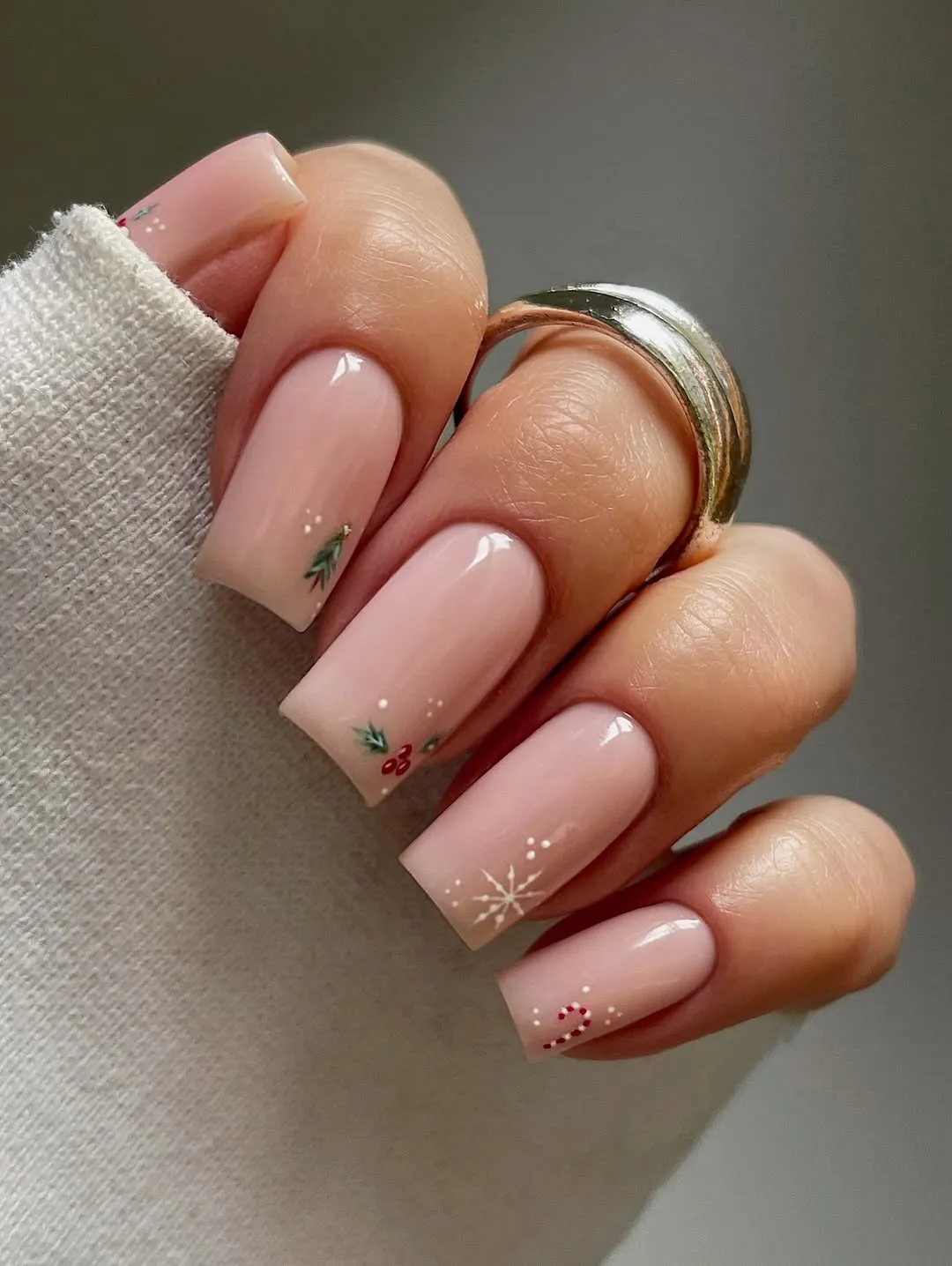 Pink manicure with snowflake and evergreen tree accent nails