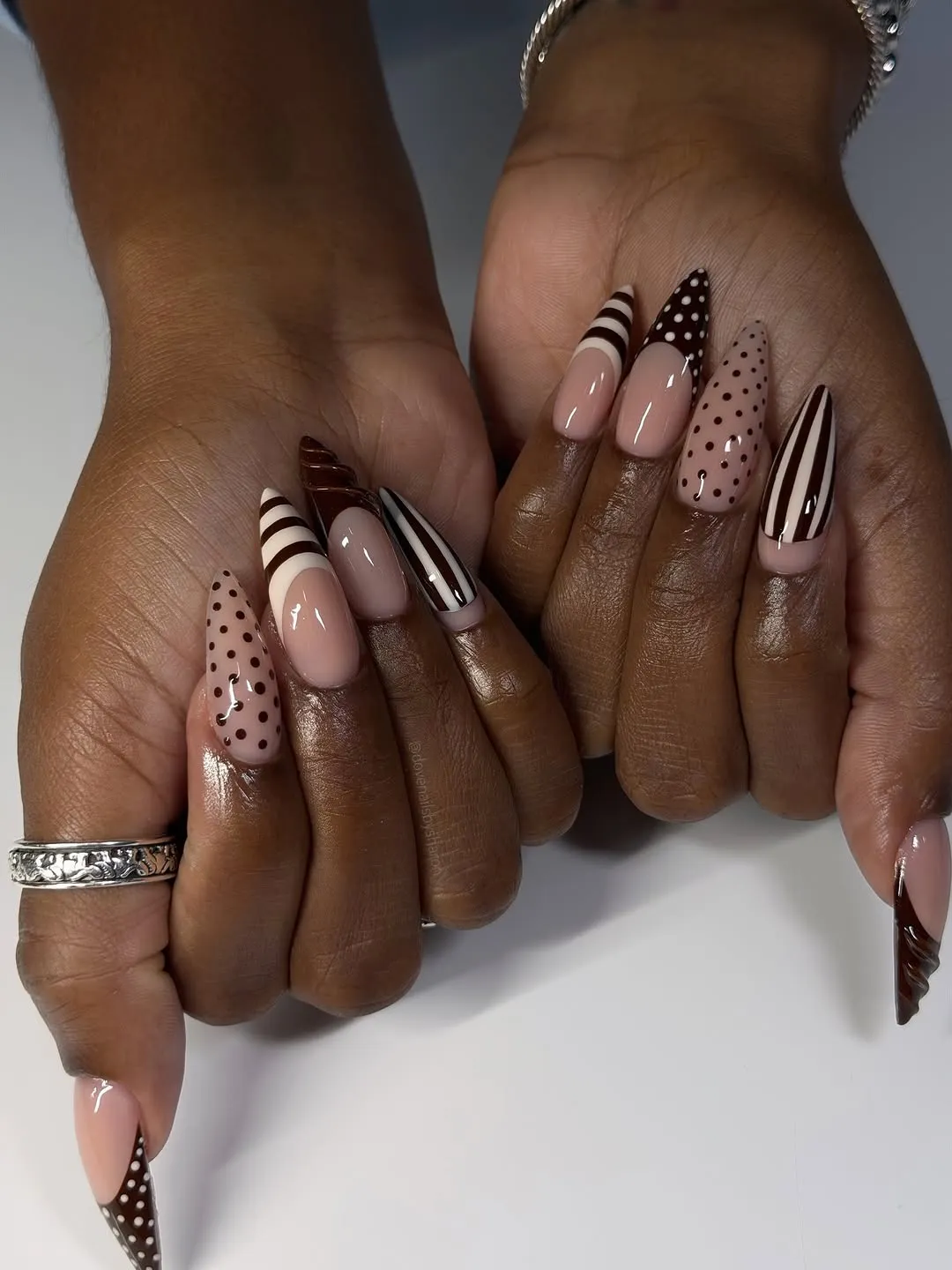 Nails with brown polka dots and stripes